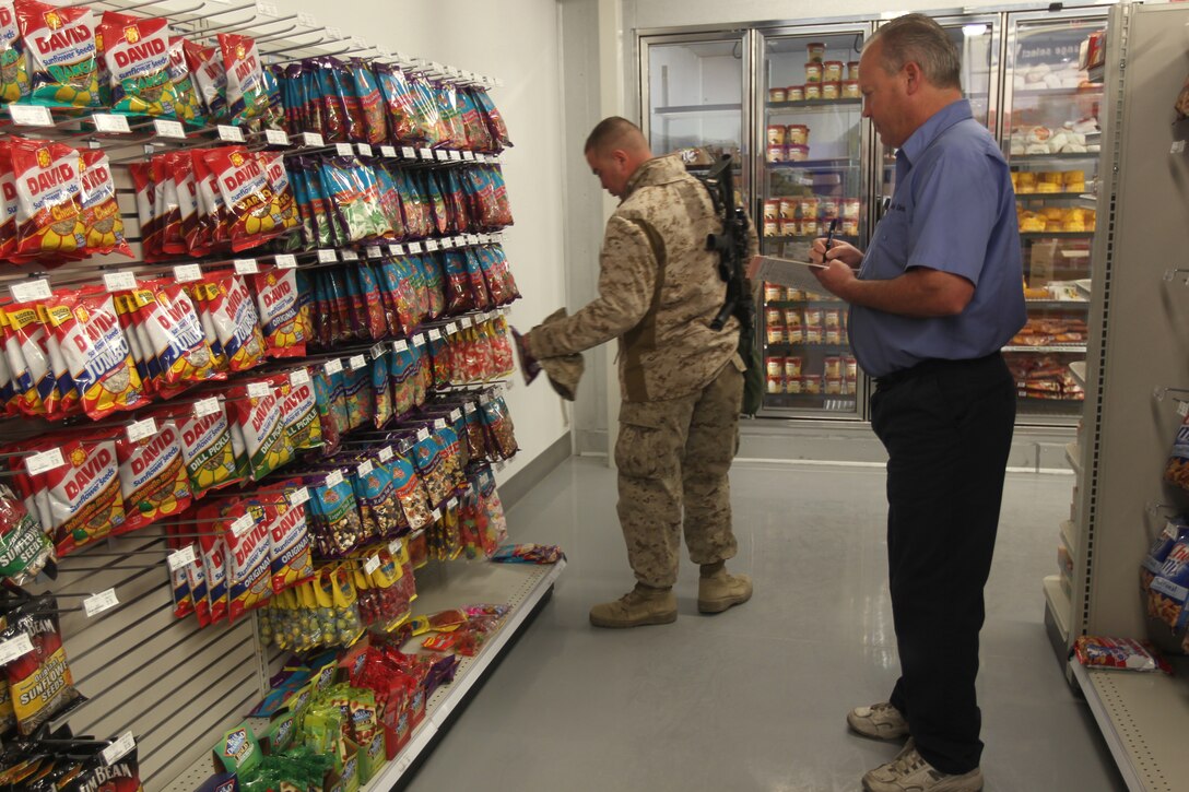 Billy McClay, with McClay Distributors, checks inventory at the Combat Center’s new Marine Corps Exchange in Camp Wilson Jan. 19, 2011. The new exchange expanded upon the old one from seven thousand square feet to approximately 11 thousand.