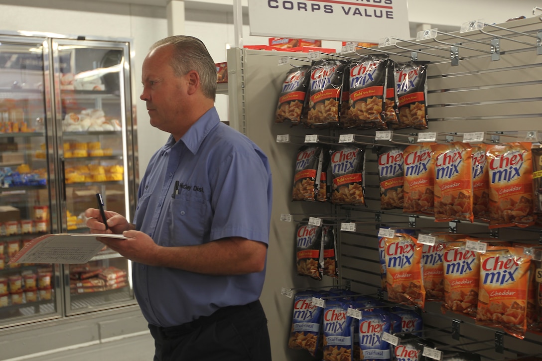 Billy McClay, with McClay Distributors, checks inventory at the Combat Center’s new Marine Corps Exchange in Camp Wilson Jan. 19, 2011. The new exchange expanded upon the old one from seven thousand square feet to approximately 11 thousand.