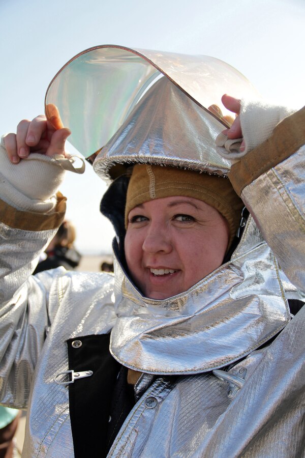 Janelle Gillis, 38, from Otsego, Minn., tries on an Aircraft Rescue Fire Fighting outfit while touring the Miramar flight line Jan. 19 during the 2011 Recruiting Station Twin Cities Educators' Workshop. Gillis is the school counselor at Maple Grove Senior High. Thirty-seven educators from Minnesota and North Dakota attended the workshop. For more photos of the event, visit the RS Twin Cities fan page at www.facebook.com/rstwincities.