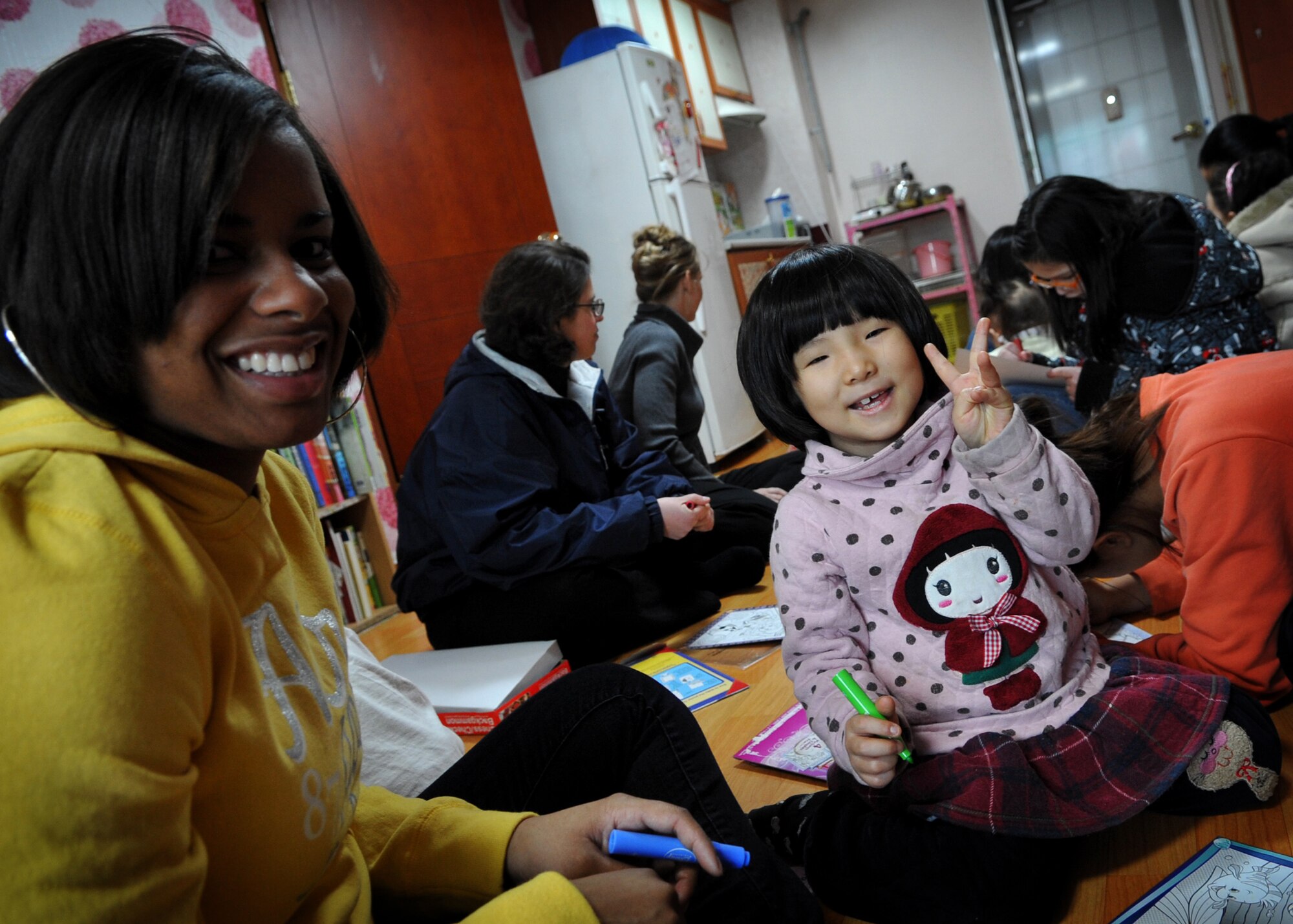 Airman 1st Class Shaquasia Dunn, 25th Fighter Squadron, plays with a child at the Cheonan orphanage during an visit by Osan Airmen Jan. 15.  The Osan base chapel organizes a monthly trip to local orphanges, where volunteers have the opportunity to play with and talk to the children. (U.S. Air Force photo by Senior Airman Evelyn Chavez)