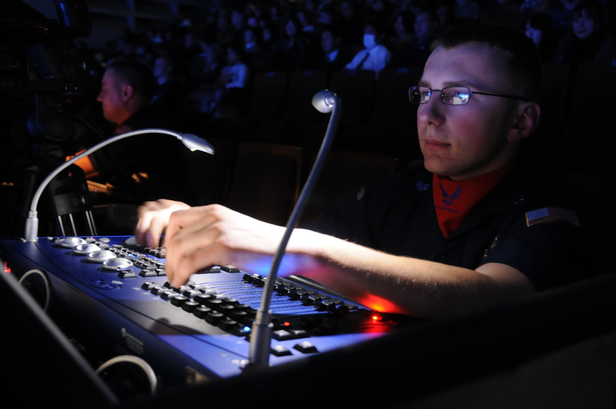 Airman 1st Class Jerry Kamysz, a Tops In Blue 2010 World Tour lighting director, controls the light board during a performance at the Misawa Civic Center Jan. 18, 2011. Airman Kamysz is assigned to the 35th Aircraft Maintenance Squadron at Misawa Air Base as a materiel management apprentice. (U.S. Air Force photo by Staff Sgt. Rachel Martinez/Released)