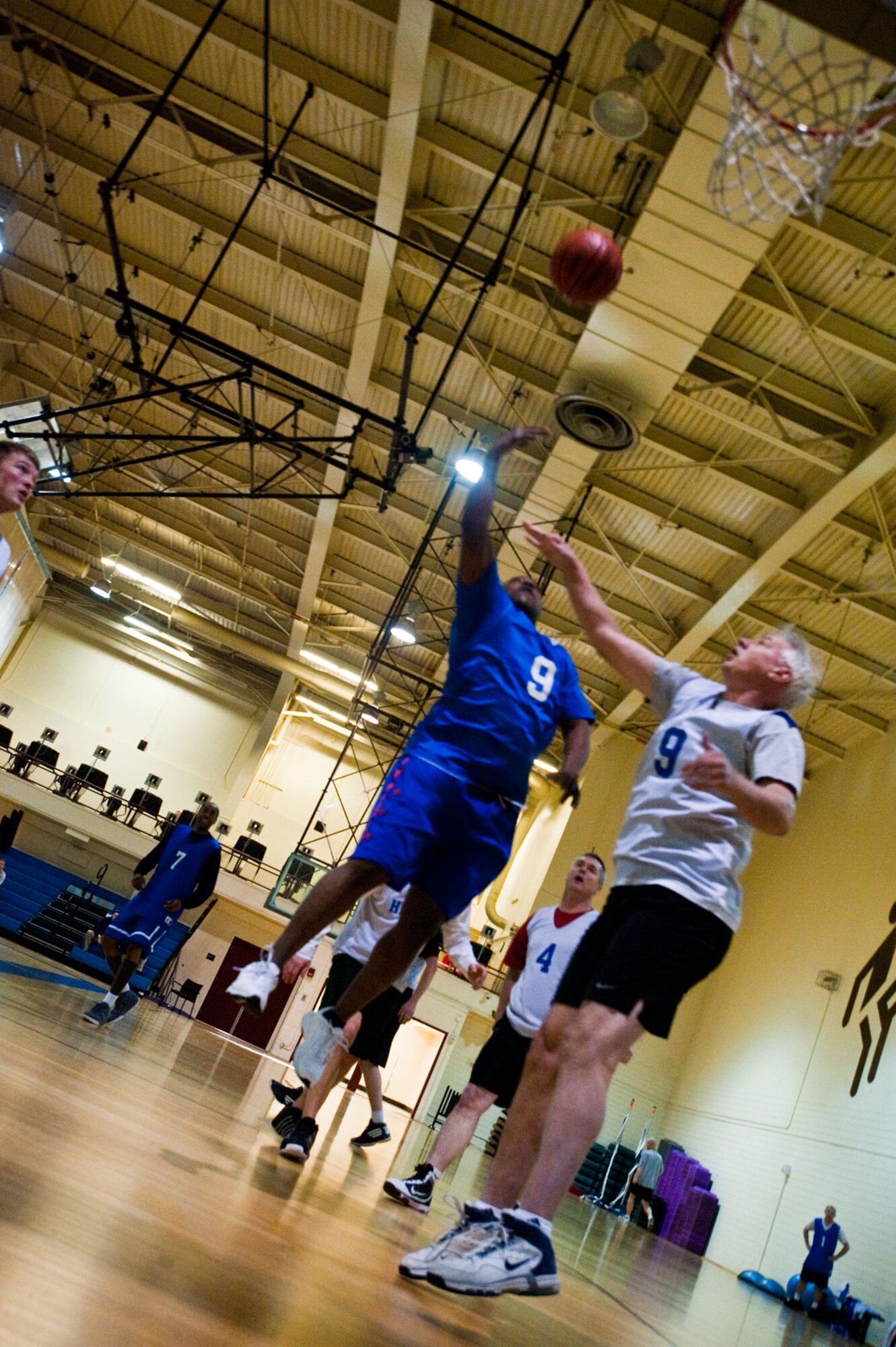 A Member of the 381st Intelligence Squadron takes a lay up shot while a member of the 673d Force Support Squadron attempts to block.  (U.S. Air Force photo/A!C Jack Sanders)