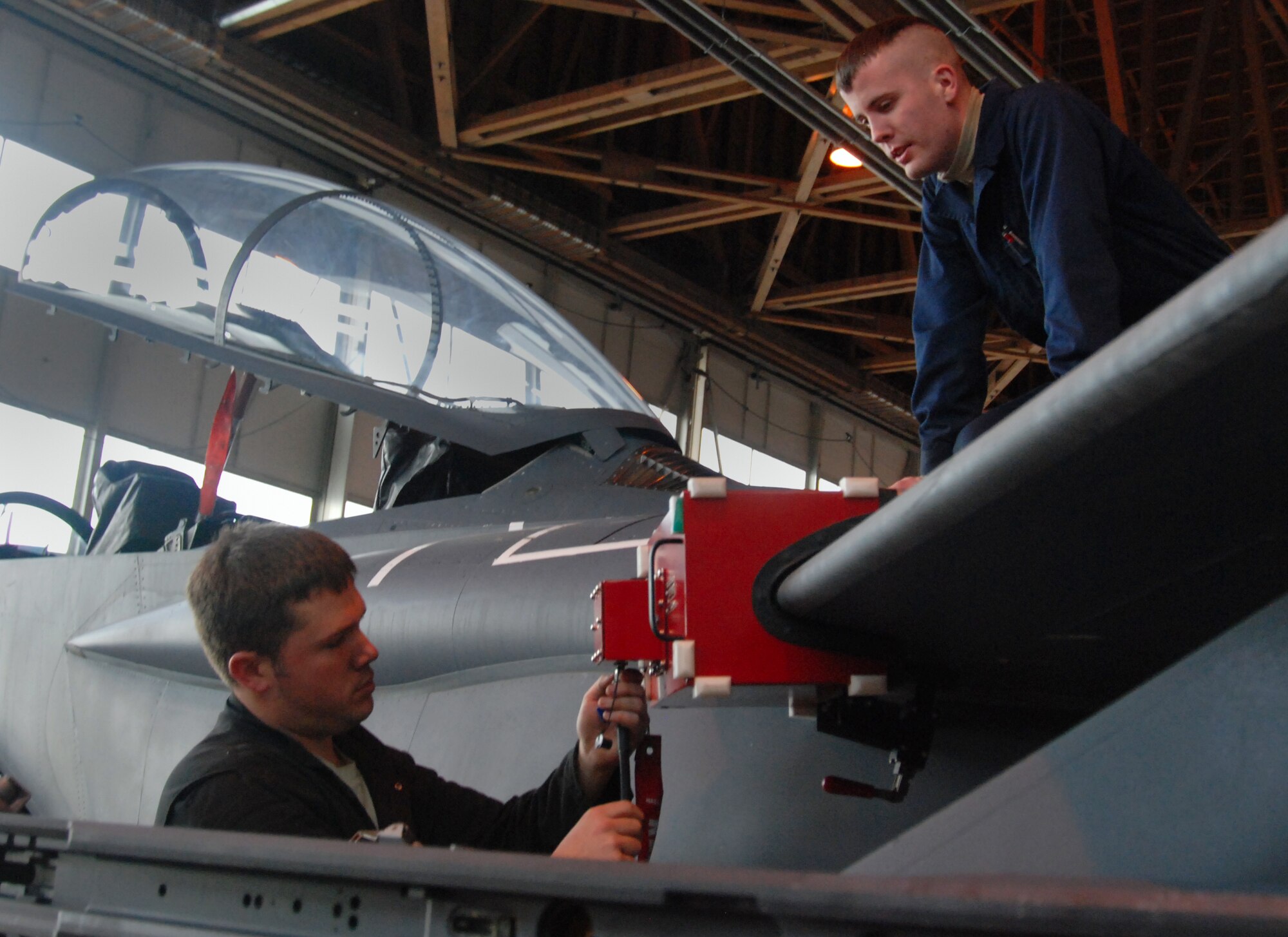 MOUNTAIN HOME AIR FORCE BASE, Idaho -- Staff Sgt. Blaine Akers and Airman 1st Class David Brennen, F-15E avionics technicians for the 366th Equipment Maintenance Squadron, prepare to run the Joint Service Electronic Countermeasures System Tester at a hangar here Jan. 18. This test helps conduct end-to-end testing of aging electronic warfare radio frequency cabling and perform full spectrum threat analysis on the base’s F-15Es. 