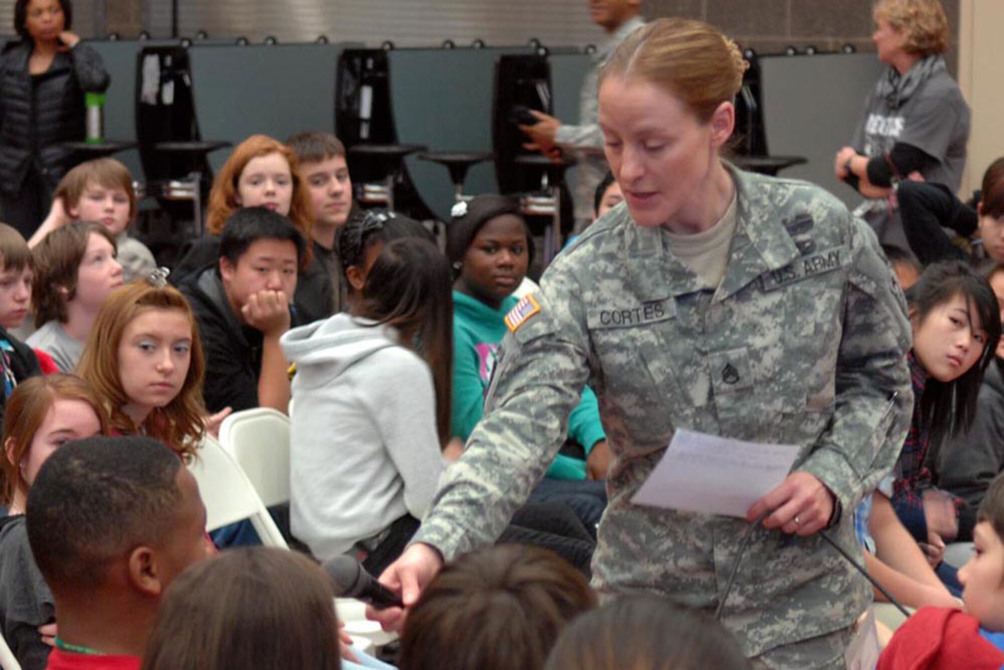 Staff Sgt. Bethany Cortes, Headquarters and Headquarters Company, 4th Brigade Combat Team (Airborne), 25th Infantry Division, takes questions from students during a Jan. 7 presentation at Begich Middle School as part of the U.S. Army Alaska and Anchorage School District Partnership Program. (U.S. Army photo/Staff Sgt. Matthew  Winstead)