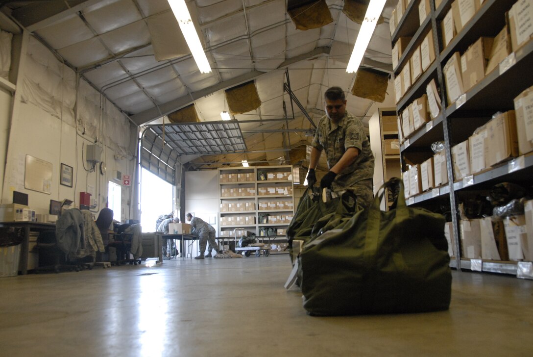 Members from the 129th Logistic Readiness Squadron's Material Management Flight, 129th Rescue Wing, Moffett Federal Airfield, Calif. assist Airmen turning in mobility bags after redeploying from overseas, Jan. 12, 2011. (Air National Guard photo by Tech. Sgt. Ray Aquino)