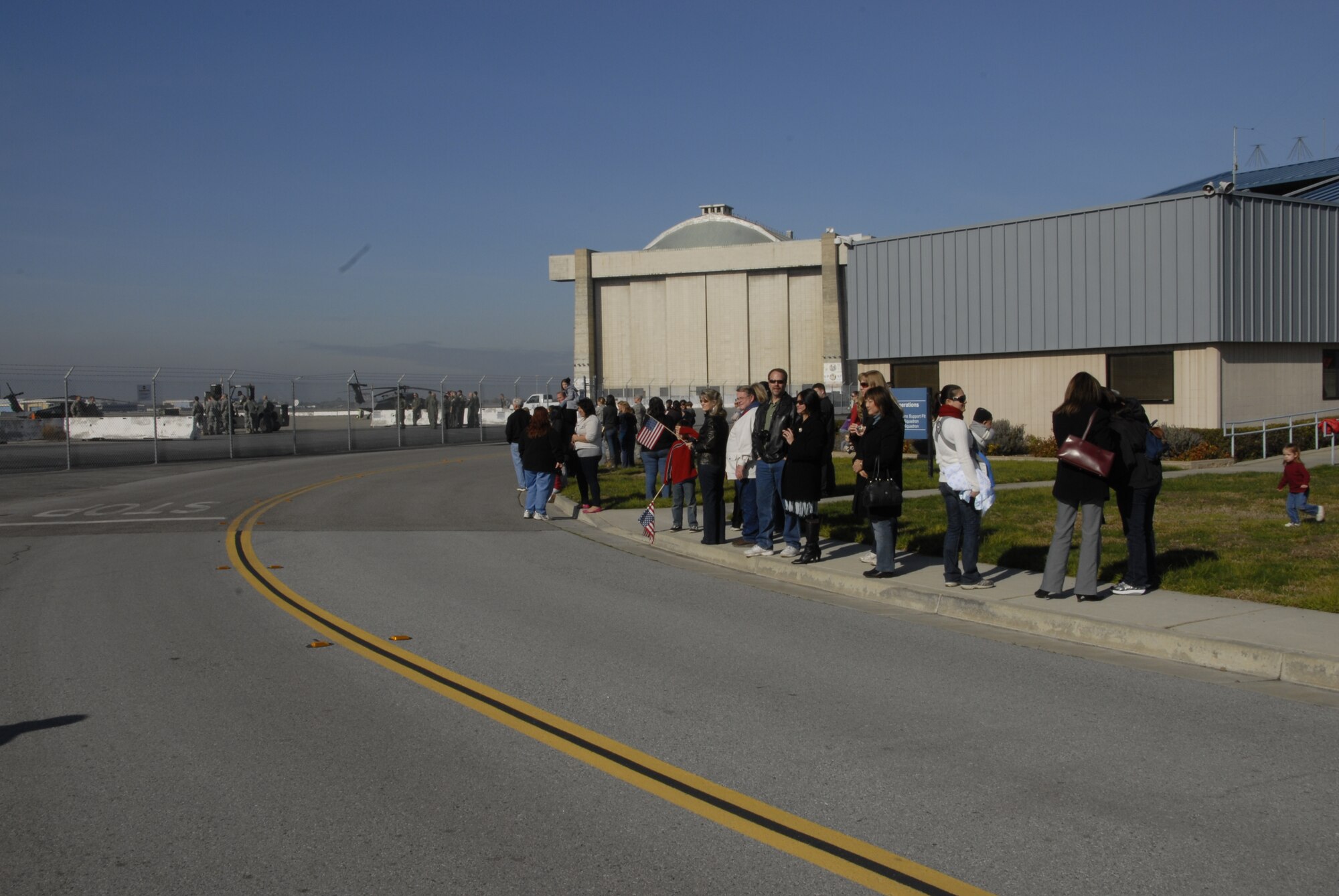 Family members and friends of deployed 129th Rescue Wing Airmen await their arrival at Moffett Federal Airfield, Calif., Jan. 12, 2011. Approximately 65 Airmen were deployed to provide combat search and rescue support for Combined Joint Task Force-Horn of Africa.  (Air National Guard photo by Tech. Sgt. Ray Aquino)