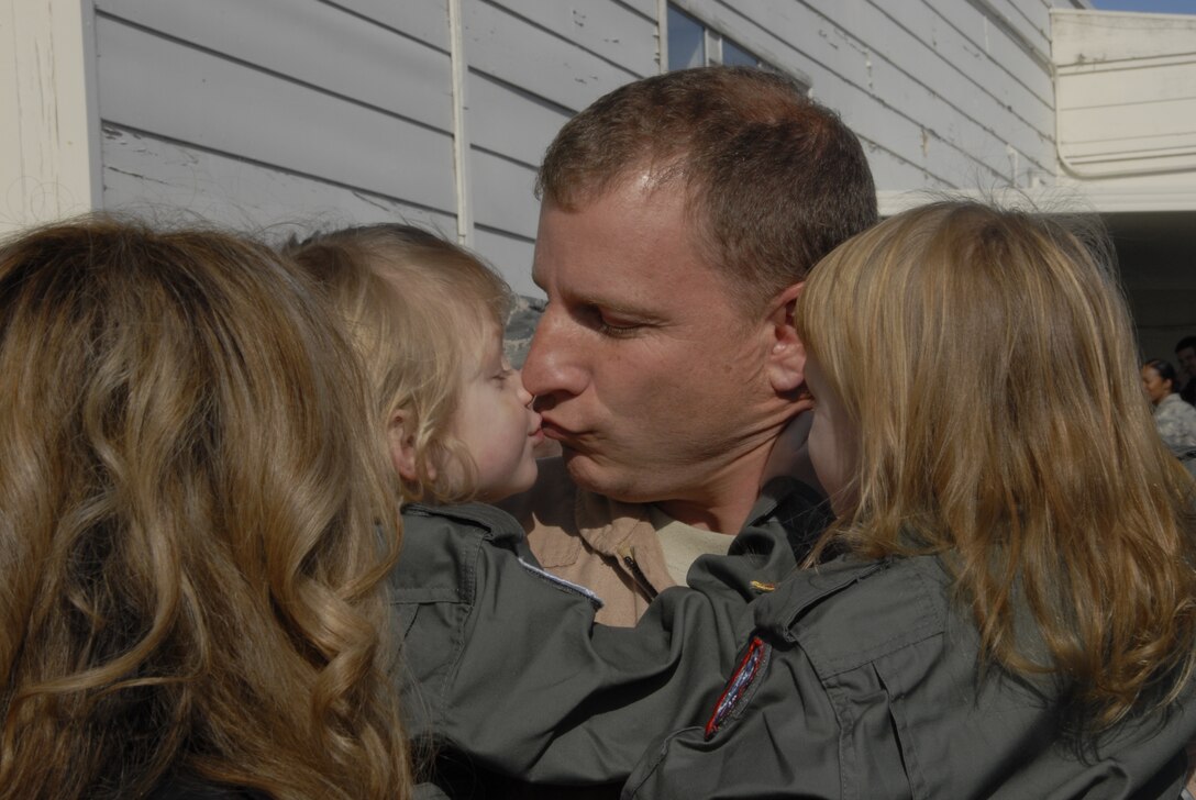 Lt. Col. Fred Foote greets his family at Moffett Federal Airfield, Calif., after redeploying from the Horn of Africa Jan. 12, 2011. Colonel Foote is the commander of the 130th Rescue Squadron at the 129th Rescue Wing. (Air National Guard photo by Tech. Sgt. Ray Aquino)