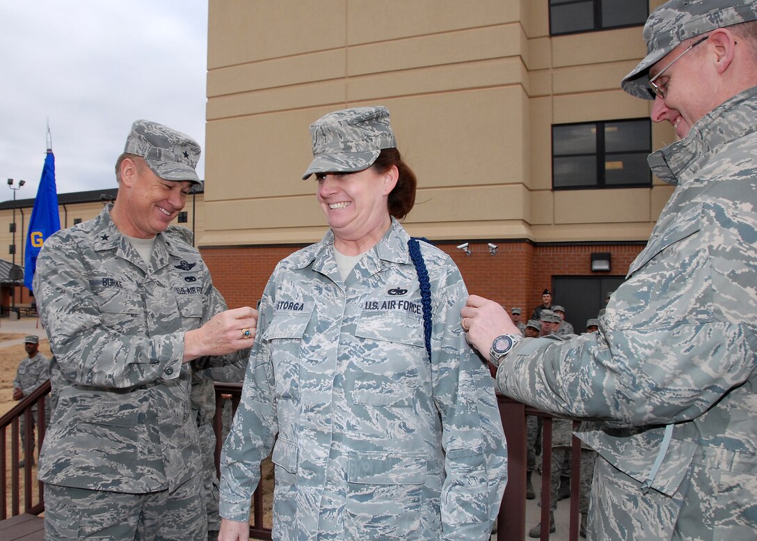 Brig. Gen. Darryl Burke, 82nd Training Wing commander, and Chief Master Sgt. David Nelson, 82nd TRW command chief, tack master sergeant stripes on Tech. Sgt. Jacquilynn Storga, 365th Training Squadron assistant flight chief, Jan. 14 and promote her on the spot. Sergeant Storga was selected for promotion under the Stripes for Exceptional Performers program. The STEP program releases a limited number of slots each year to major commands to fill for ranks E-5 through E-7. (U.S. Air Force photo/ Mike Litteken)