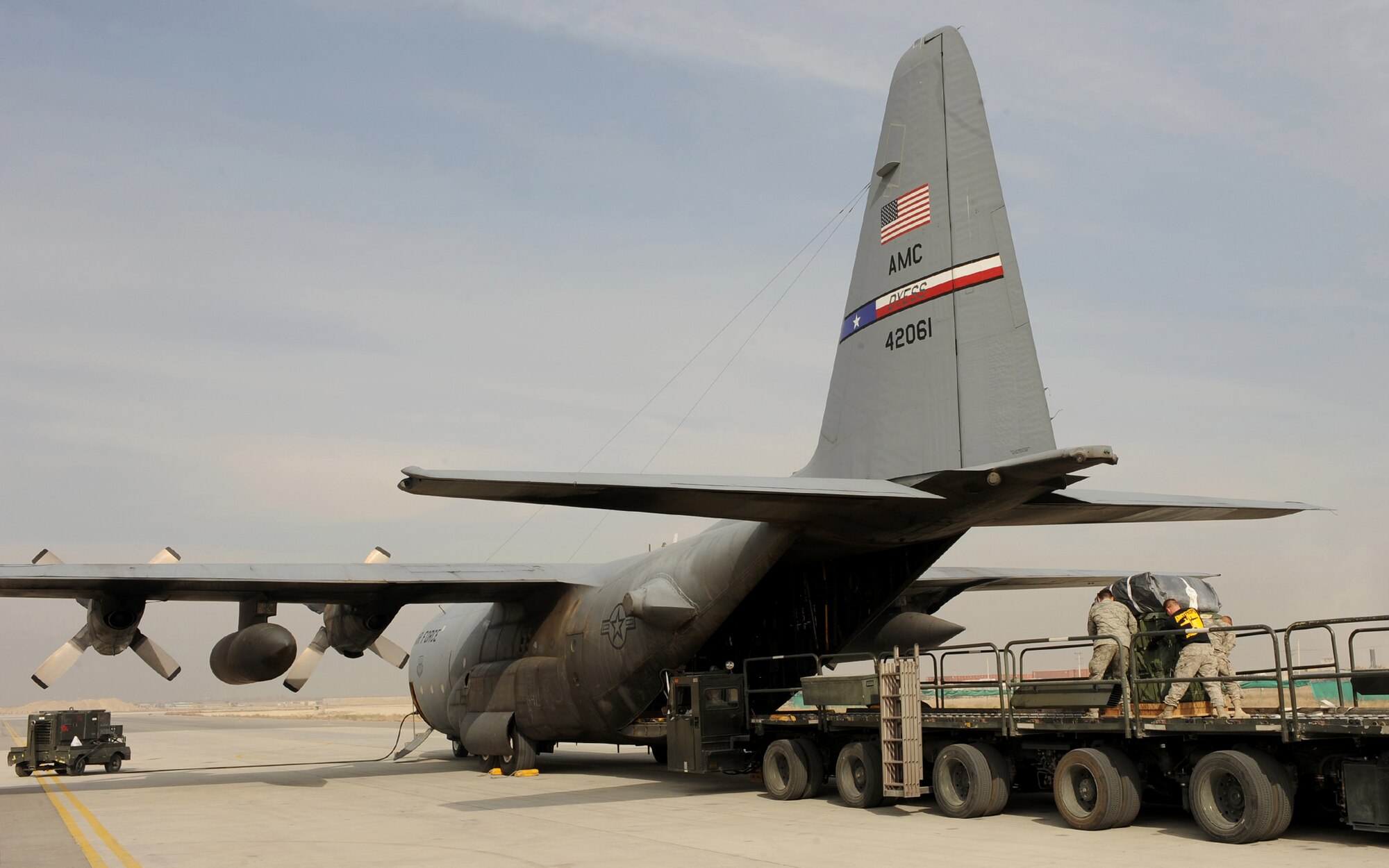 Airmen and Soldiers help load Container Delivery System bundles into the back of a C-130 Hercules recently at Bagram Airfield, Afghanistan. For the first time since the 386th Air Expeditionary Wing stood up more than a decade ago, a crew from the wing's 737th Expeditionary Airlift Squadron flew over the mountains of Afghanistan and dropped more than 22,000 pounds of supplies to ground troops Nov. 21, 2010, validating the wing's ability to perform airdrop missions in support of Operation Enduring Freedom. (Courtesy photo)
