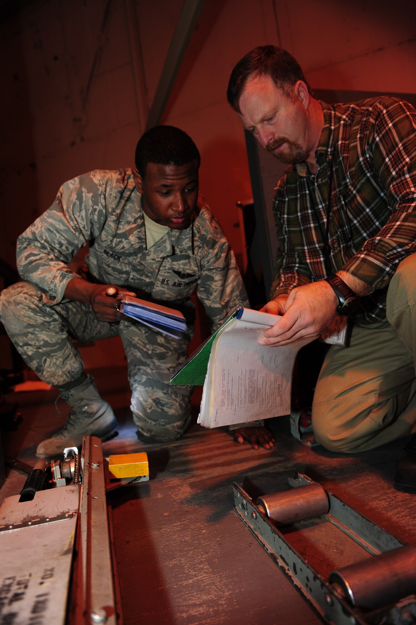 Todd Garland, Lockheed Martin instructor loadmaster from Bloomsdale, Miss., instructs Airman Basic Alejandro Black, 714th Training Squadron loadmaster student from Beaufort, S.C., on C-130E and C-130H loadmaster initial qualification training Jan. 19, 2011, at Little Rock Air Force Base. Loadmasters go through 60 days of loadmaster initial qualification and 21 days of loadmaster mission qualification training before being assigned to a duty station. (Photo by U.S. Air Force Senior Airman Jim Araos)