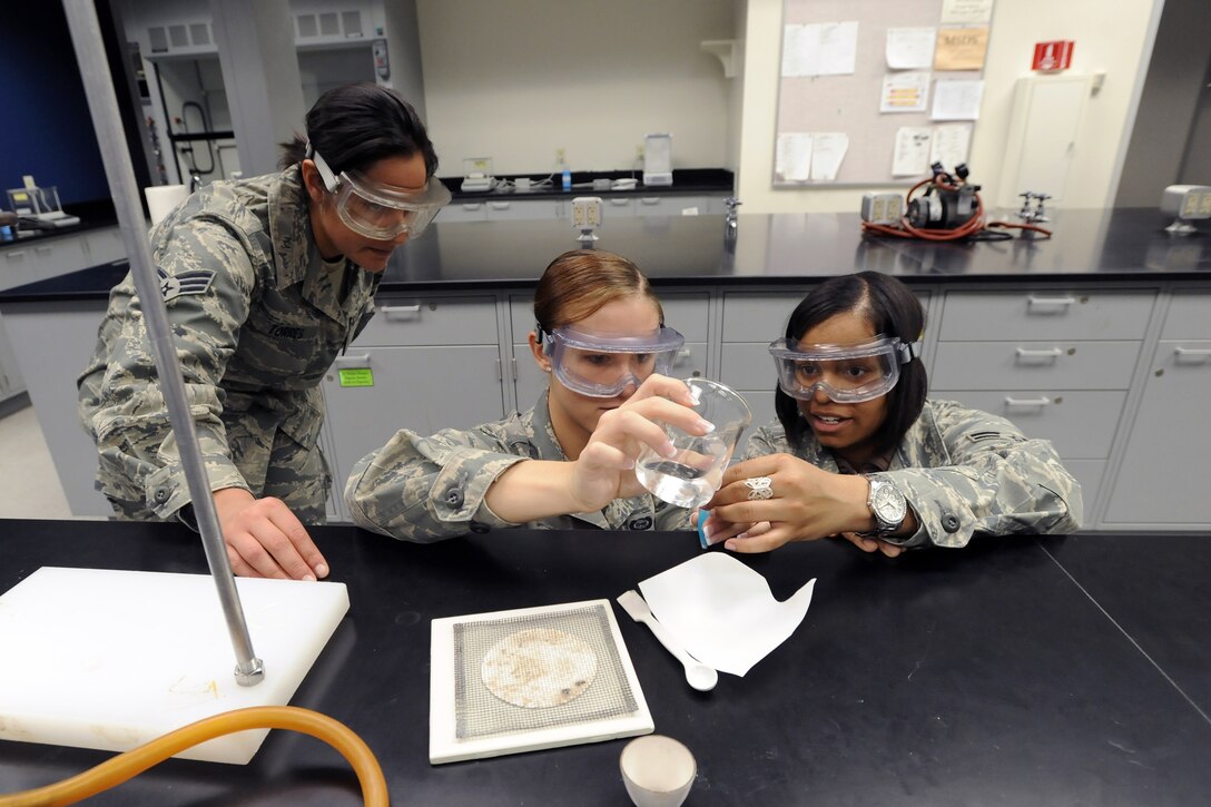 From left: Senior Airman Magdalena Torres, Cadet 4th Class Chelsea Renfro and Airman 1st Class Janeka Perry conduct a chemistry experiement while visiting the Air Force Academy in Colorado Springs, Colo., Jan. 14, 2011. Airmen Torres and Perry took part in a Leaders Encouraging Airmen Development Diversity Visitation Program Jan. 14 and 15. Airman Torres is assigned to the 914th Maintenance Squadron at Niagara Falls Air Reserve Station, N.Y. Airman Perry is assigned to the 137th Airlift Control Flight at Tinker Air Force Base, Okla. (U.S. Air Force photo/Johnny Wilson)