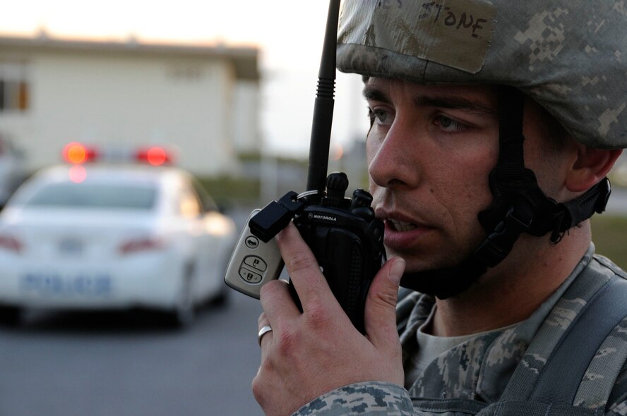Staff Sgt. James Stone, 18th Security Forces Squadron, radios information about a simulated building evacuation to his command at Kadena Air Base, Japan, Jan. 19. This scenario, which tested the 18th SFS's ability to respond to a building attack with casualties, was part of Beverly High 11-02, a Local Operational Readiness Exercise held here. (U.S. Air Force photo/Staff Sgt. Darnell T. Cannady) 