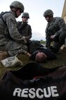 Members of the 18th Security Forces Squadron use equipment from a first aid kit to treat simulated injuries at Kadena Air Base, Japan, Jan. 19. This scenario, which tested the 18th SFS's ability to respond to a building attack and provide care to injured personnel, was part of Beverly High 11-02, a Local Operational Readiness Exercise held here. (U.S. Air Force photo/Staff Sgt. Darnell T. Cannady) 