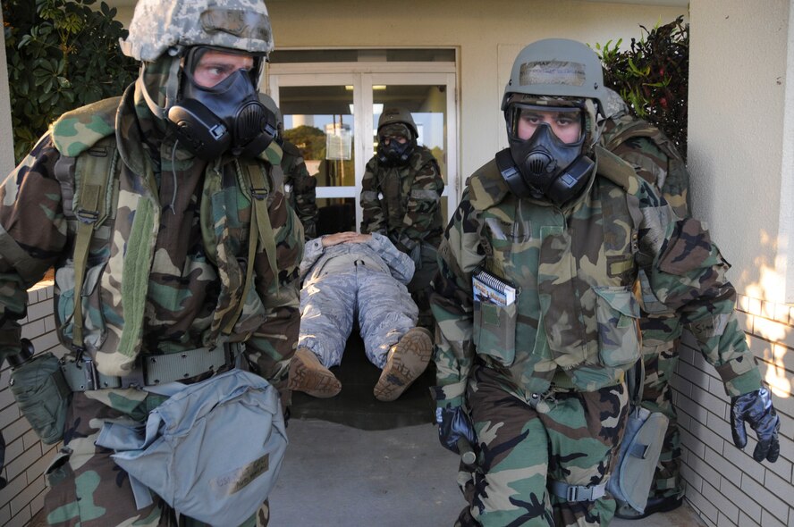 Members of the 18th Operational Support Squadron use a litter to transport a simulated injured Airman to an alternate facility during a building evacuation scenario at Kadena Air Base, Japan, Jan. 19. This scenario, which tested the 18th OSS's ability to evacuate and secure a building until security forces personnel arrive, was part of Beverly High 11-02, a Local Operational Readiness Exercise held here. (U.S. Air Force photo/Staff Sgt. Darnell T. Cannady)