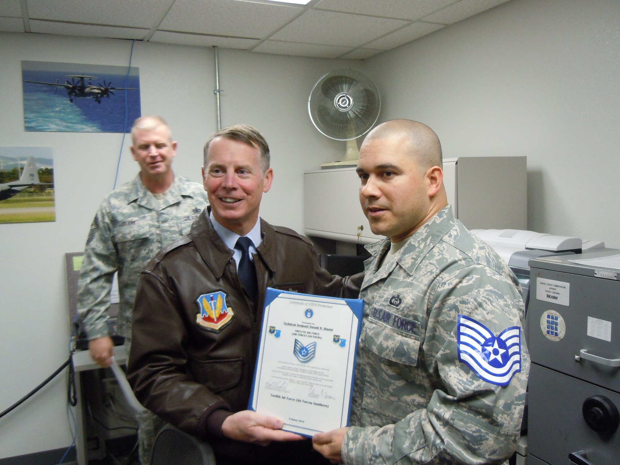 Lt. Gen. Glenn Spears, 12th Air Force (Air Forces Southern) commander bestows technical sergeant stripes to Staff Sgt. Donald Blasini Jan. 5, 2011. Now Tech. Sgt. Blasini, 612th Support Squadron, was promoted under the Stripes for Exceptional Performers program, and the promotion was a surprise for the NCO. (Courtesy photo)