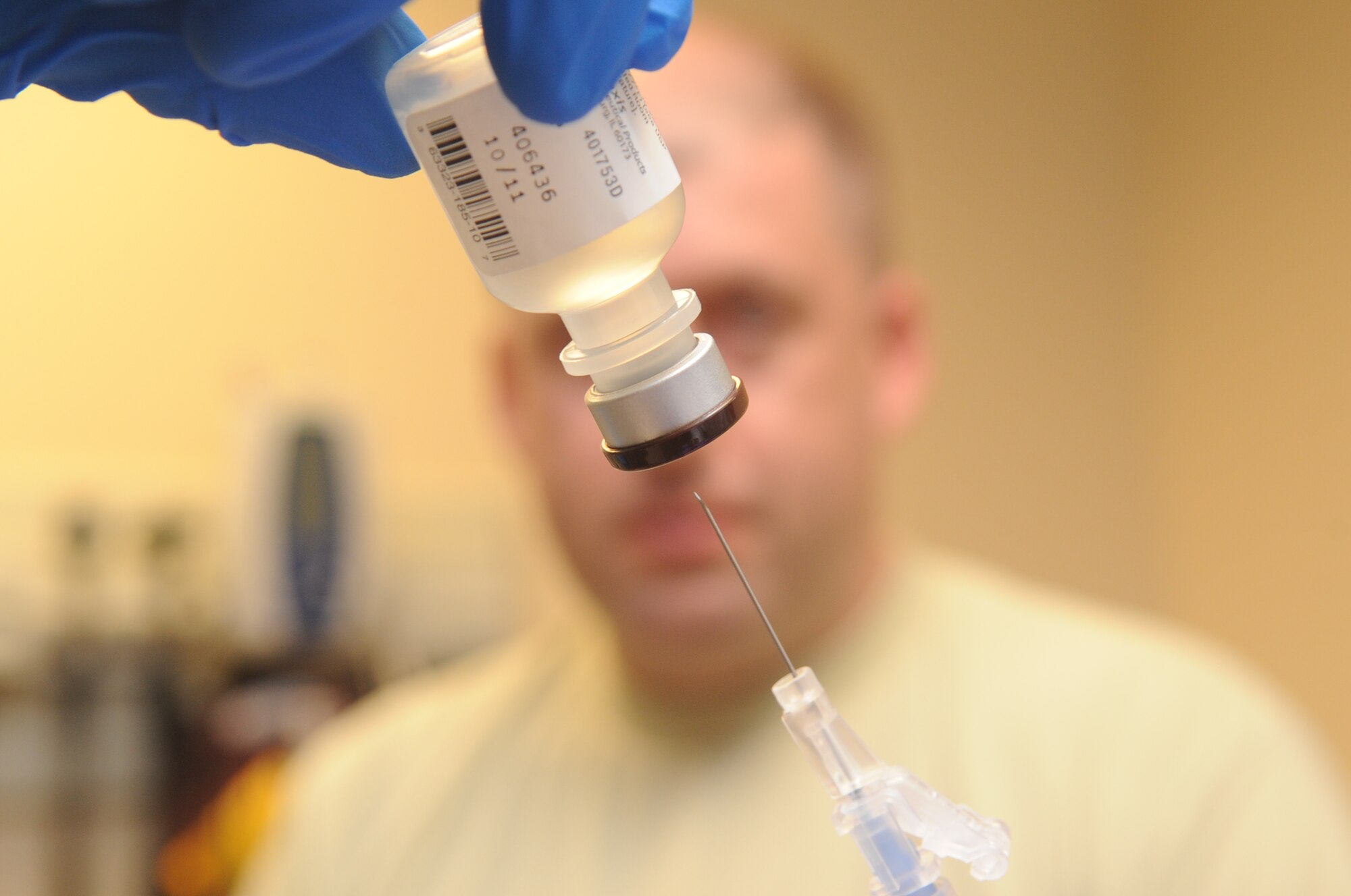 Buckley Air Force Base, Colo.-  A needle is inserted into a bottle of medicine during a patients visit to the 460th Med Group, Jan. 19, 2011.   ( U.S. Air Force Photo by Airman First Class Marcy Glass )