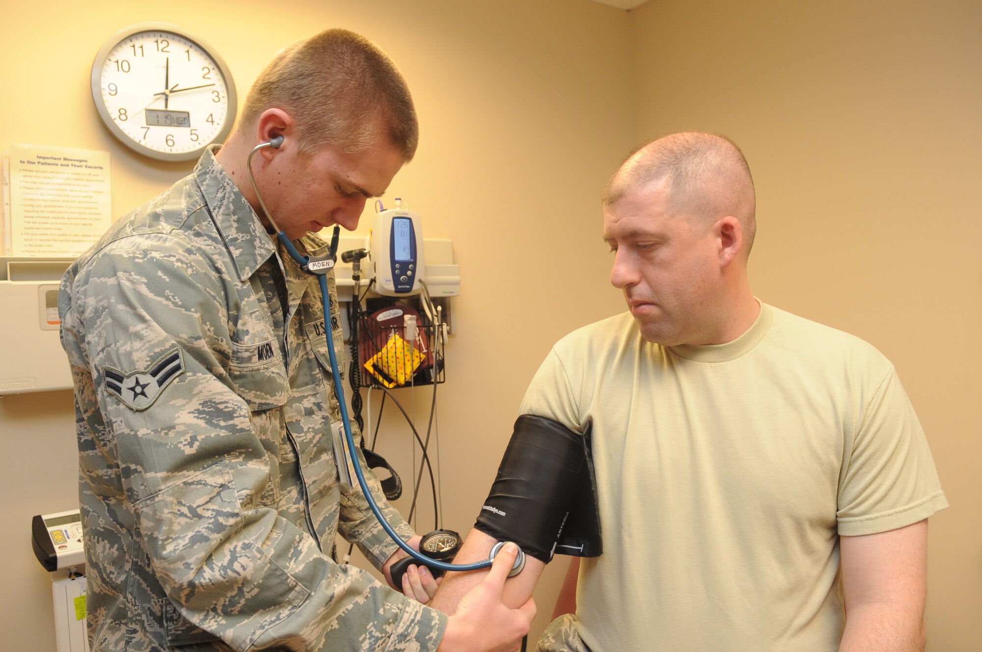 Buckley Air Force Base, Colo.-  Airman 1st Class Josh Moen, 460th Med Group, takes a patients blood pressure , Jan. 19, 2011. Airman Moen was recognized during the 460th Med Group's Inspection.  ( U.S. Air Force Photo by Airman First Class Marcy Glass )

