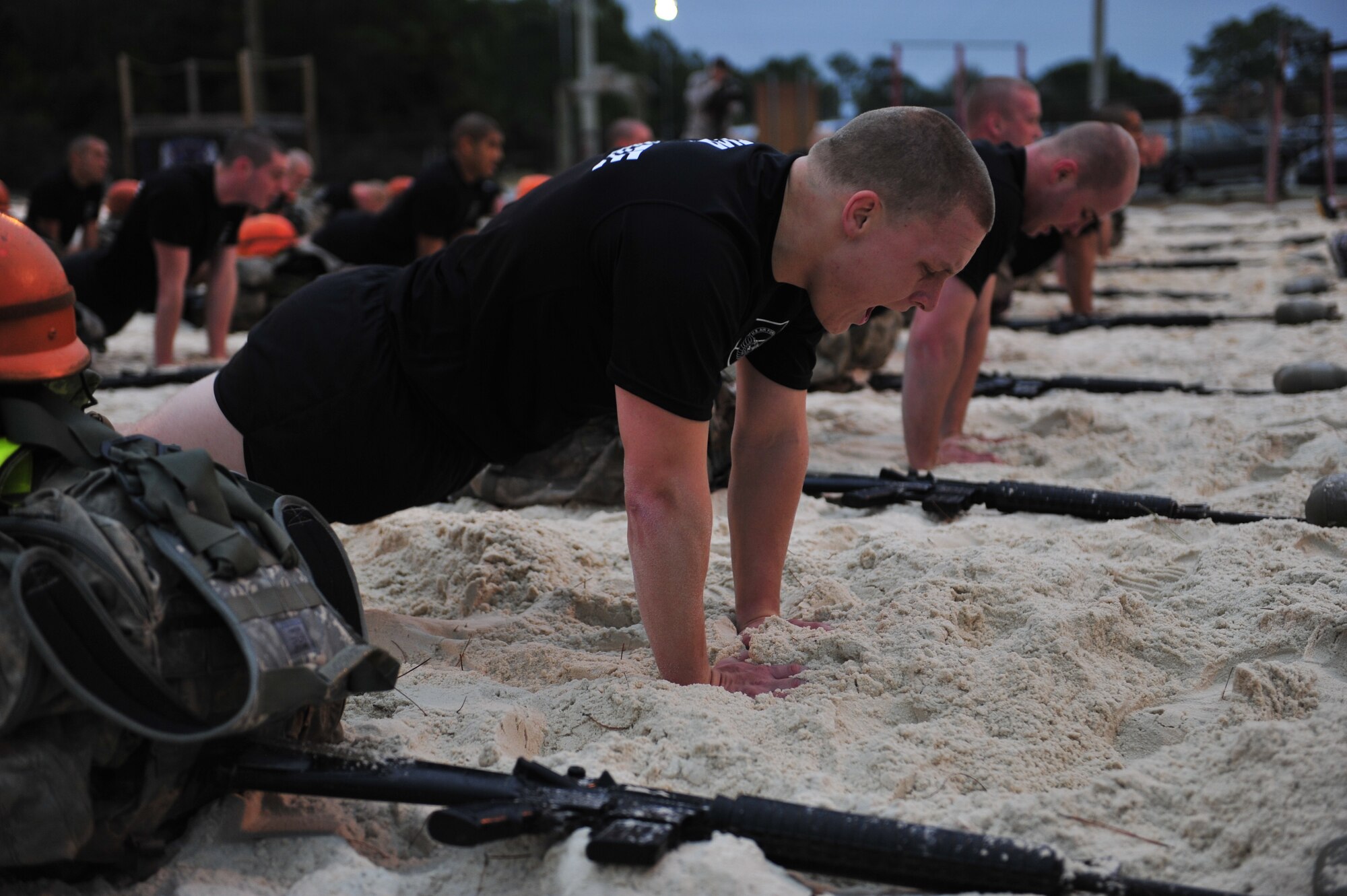U.S. Air Force Tactical Air Control Party candidates perform push-ups during their first physical training session, Hurlburt Field, Fla., Jan. 5, 2011. The TACP technical training school involves rigorous academic and physical training standards. TACPs establish and maintain command and control communications, control air traffic and naval gunfire and provide precision terminal attack guidance of U.S. and coalition close air support. (U.S. Air Force photo by Staff Sgt. Stephanie Jacobs/RELEASED)

