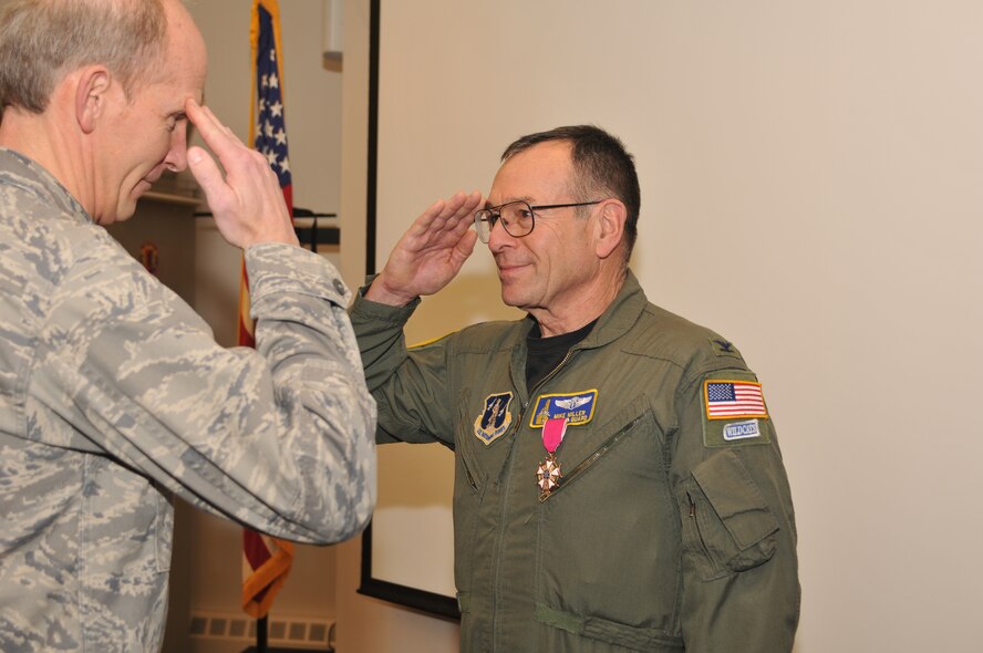 Colonel Michael "Doc" Miller (right) salutes during his retirement ceremony after being awarded the Legion of Merit medal by Major General William N. Reddel III, NH Adjutant General, Pease Air National Guard Base, Newington, NH, January 8, 2011.  The Legion of Merit recognizes the exceptional meritorious conduct in the performance of outstanding service to the United States. (released/U.S. Photo by Master Sgt. Timothy W. Psaledakis)