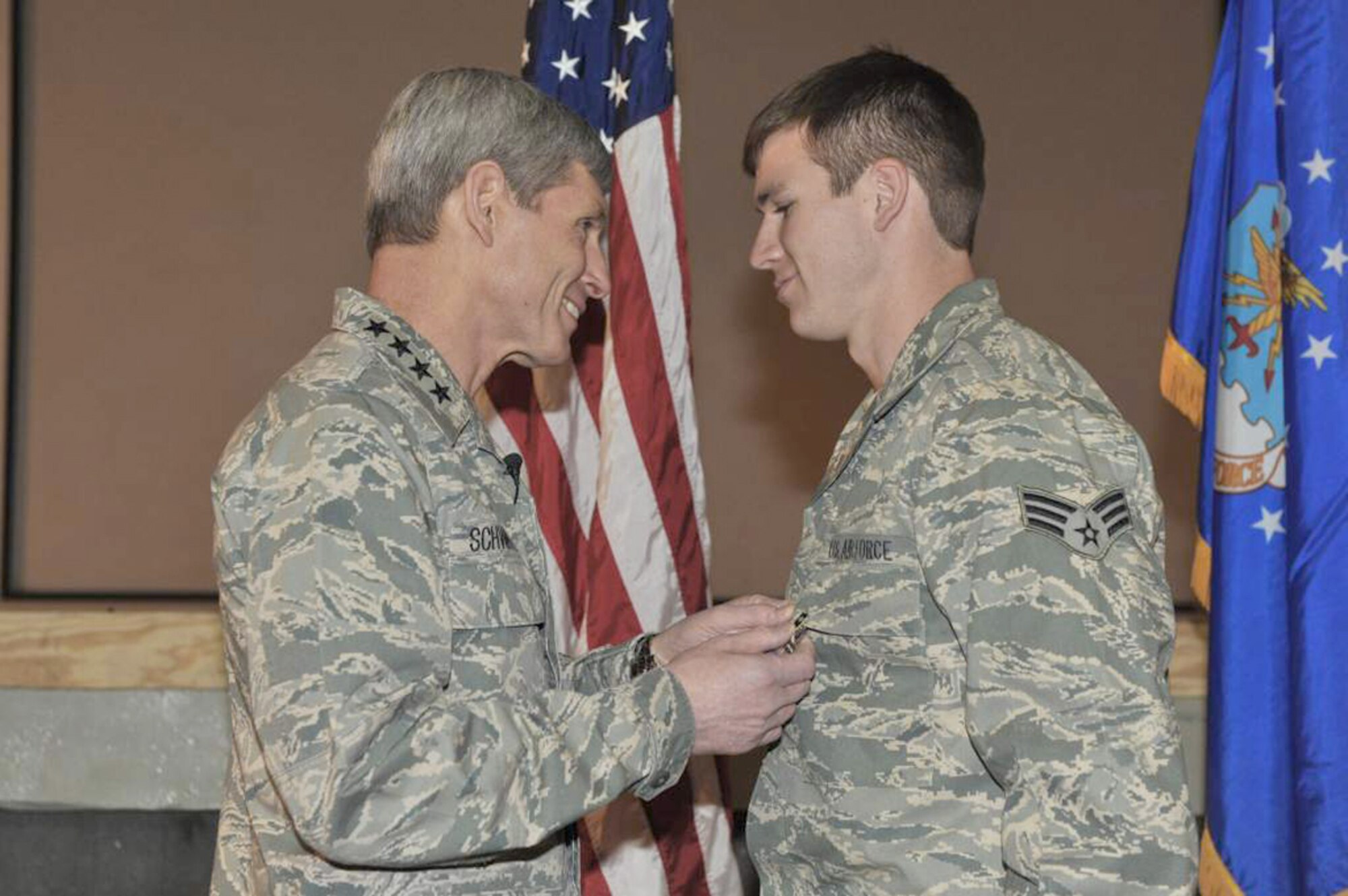 Air Force Chief of Staff Gen. Norton Schwartz pins a Purple Heart medal on Senior Airman Brandon Cullen Towle, a joint terminal attack controller assigned to the 817th Expeditionary Air Support Operations Squadron, during a ceremony at Bagram Airfield, Afghanistan, on Jan. 19, 2011.  (U.S. Air Force photo)