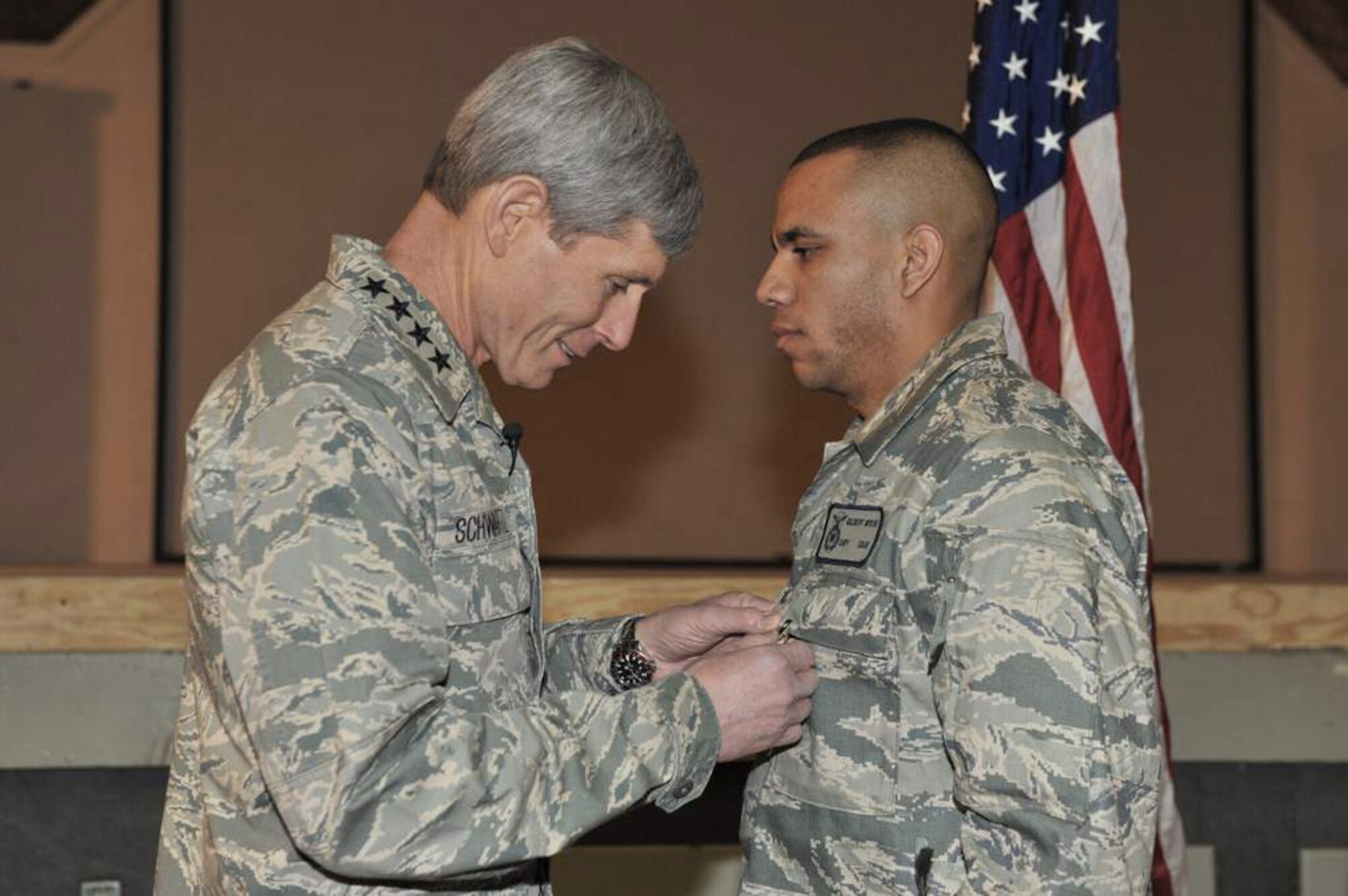 Air Force Chief of Staff Gen. Norton Schwartz pins a Purple Heart medal on Capt. Gil Wyche, a security forces officer assigned to the 966th Air Expeditionary Squadron, during a ceremony at Bagram Airfield, Afghanistan, on Jan. 19, 2011. (U.S. Air Force photo)