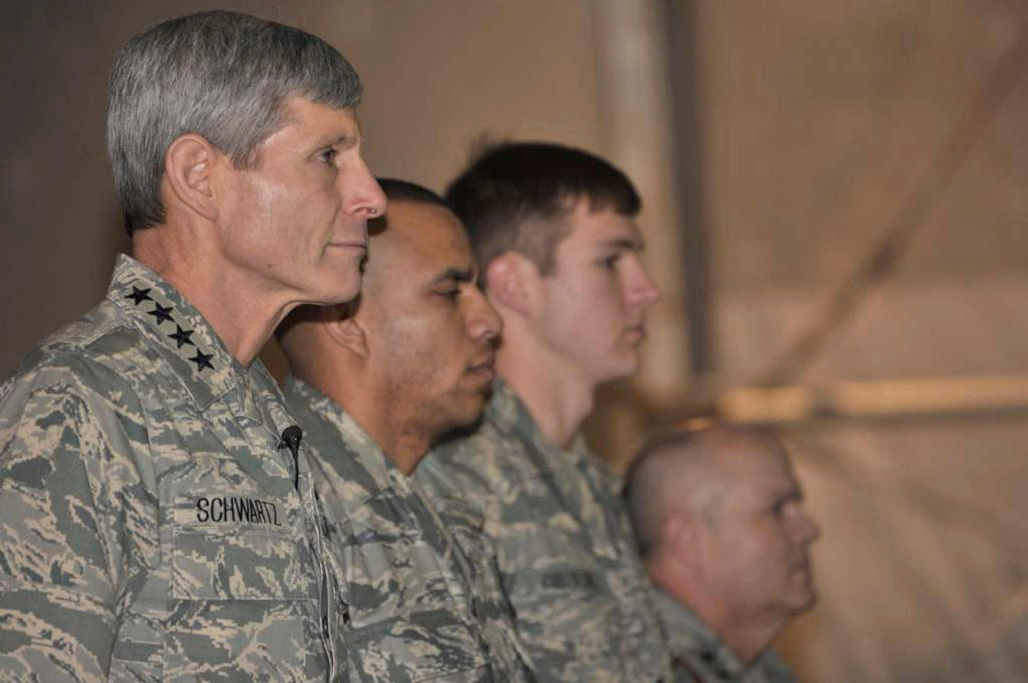 (From left) Gen. Norton Schwartz, Air Force chief of staff; Capt. Gil Wyche, a security forces officer assigned to the 966th Air Expeditionary Squadron; Senior Airman Brandon Cullen Towle, a joint terminal attack controller assigned to the 817th Expeditionary Air Support Operations Squadron; and Maj. Gen. Charles W. Lyon, 9th Air and Space Expeditionary Task Force-Afghanistan commander, stand at attention during a Purple Heart presentation ceremony at Bagram Airfield, Afghanistan, on Jan. 19, 2011.  General Schwartz presented Captain Wyche and Airman Cullen Towle with Purple Hearts during the ceremony. (U.S. Air Force photo)