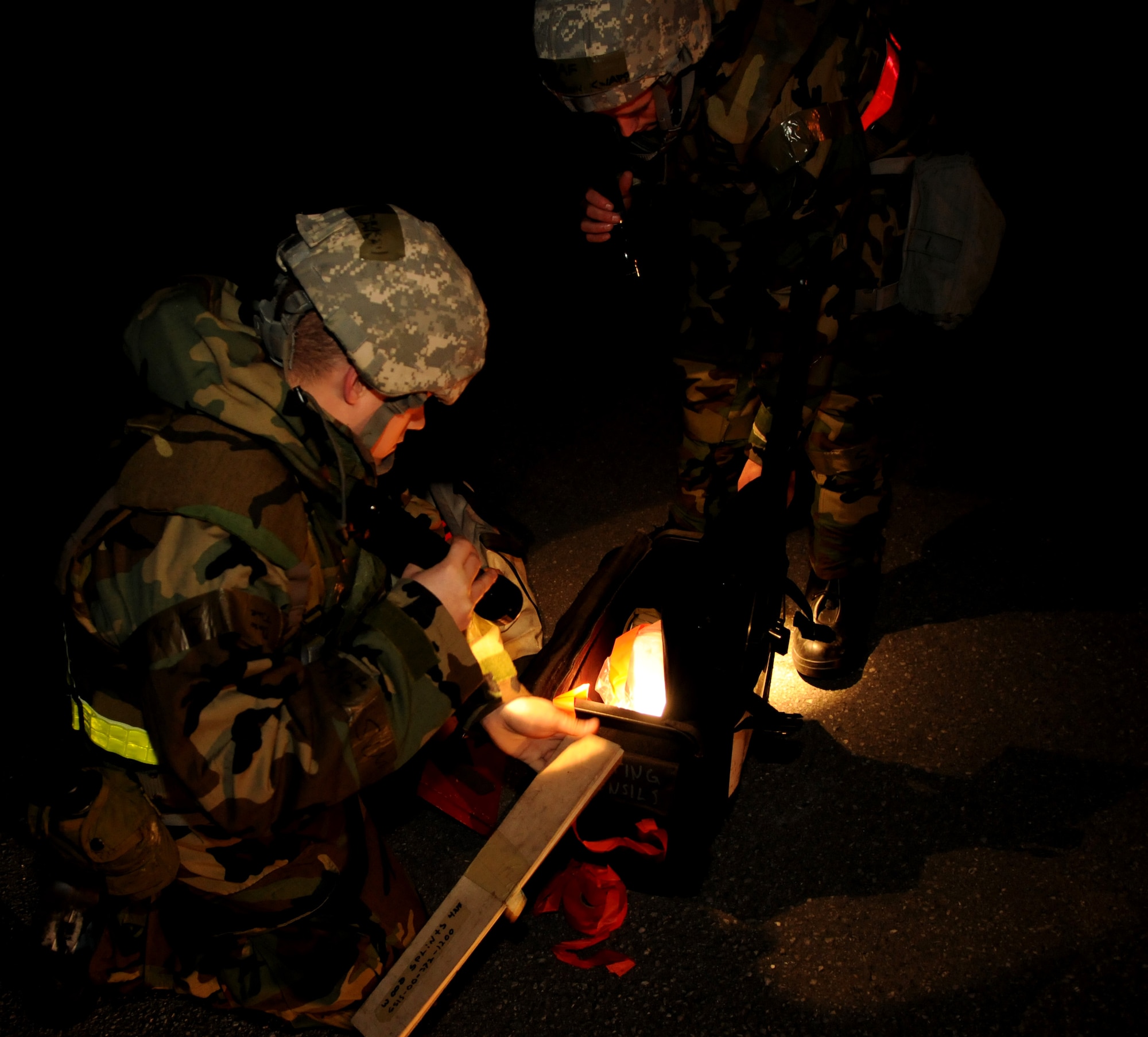 With the help of Airman 1st Class Jon Knapp (right), Senior Airman Alexander Davison, 18th Equipment Maintenance Squadron aerospace ground equipment journeyman, takes out a stake to mark a cordoned parameter of a potential unexploded ordnance during exercise Beverly High 11-02 on kadena Air Base, Japan, Jan. 20. Using the marker helps ensure others don't enter the potentially hazardous area. (U.S. Air Force photo/ Airman 1st Class Jarvie Z. Wallace)