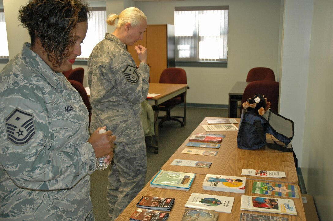 First Sergeants Tia Moore (front), 512th Logistics Readiness Flight, and Sheryl Donley, 512th Security Forces Squadron, look over pamphlets Jan. 9 before the start of the AF&R First Sergeants Luncheon at Dover Air Force Base, Del. The two master sergeants attended the annual event which showcased various A&FR programs. (U.S. Air Force photo by Senior Airman Dani Shea/Released)
