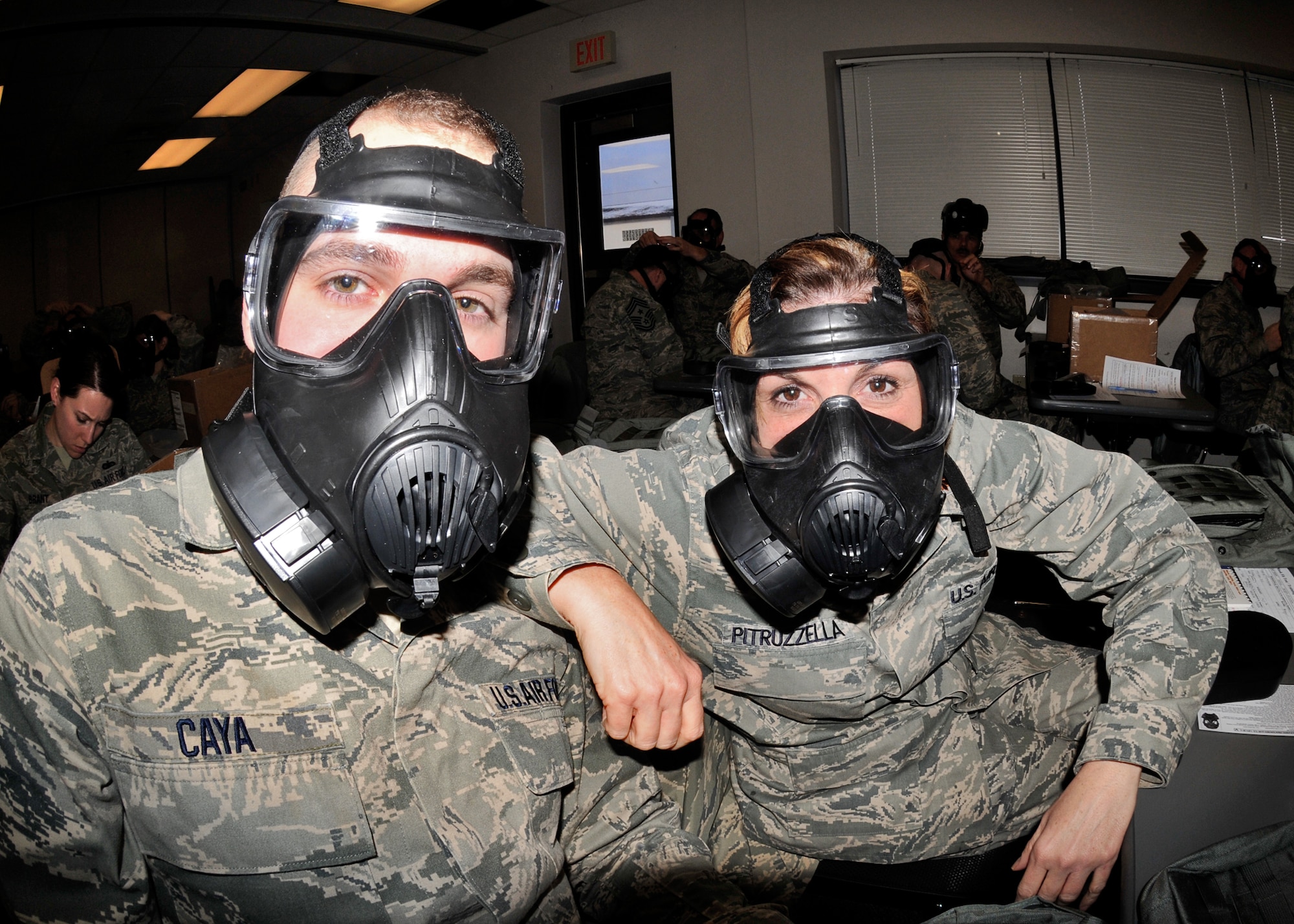 914th Airlift Wing members Maj. Andrea Pitruzzella (right) and Senior Airman Andrew Caya being issued and trained in the basics of the new M50 Joint Service General Purpose Mask January 9 2011 Niagara Falls Air Reserve Station, Niagara Falls, NY. The M50 Joint Service General Purpose Mask will be the standard for the United States Armed Forces. (U.S. Air Force photo by Staff Sgt. Joseph McKee)