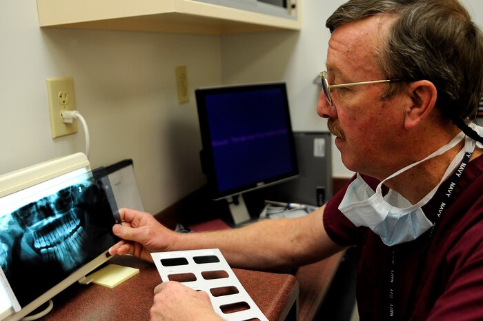 Navy Capt. Dr. William Reynolds (retired) checks a patient’s x-rays prior to an examination at Naval Health Clinic Charleston Dental, Jan. 13. An x-ray can tell a doctor if there are problems with a patient’s jaw and show cavities or other issues concerning the teeth. (U.S. Navy photo/Mass Communication Specialist 1st Class Jennifer R. Hudson)