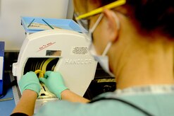 Diane Wilson, a dental technician at Naval Health Clinic Charleston Dental, trims a diagnostic cast on the model trimmer, Jan. 13. The diagnostic cast shapes soft night guards, which help prevent patients from grinding their teeth during sleep. The occasional grinding of teeth does not usually harm a person, however, if the grinding occurs on a regular basis, damage and other oral health complications could arise. On average, NHCC Dental makes four soft night guards each month. (U.S. Navy photo/Machinist’s Mate 3rd Class Brannon Deugan) 


