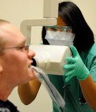 Hospital Corpsman Seaman Sayphonh Khammala prepares to take an x-ray of Fireman Johnnie Williams’ teeth. The x-ray will tell the dentist if there are any cavities or jaw issues and if there are any molars or premolars. Naval Health Clinic Charleston Dental takes approximately 200 x-rays weekly. (U.S. Navy photo/Mass Communication Specialist 1st Class Jennifer R. Hudson)