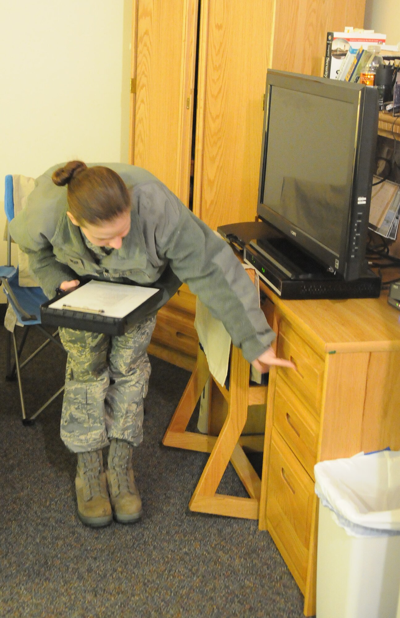Staff Sgt. Stephanie Bandy checks an Airman's room during a room inspection Jan. 11, 2011, Eielson Air Force Base, Alaska. Airmen Dormitory Leaders perform inspections to ensure the buildings are maintained and clean. Sergeant Bandy is a 354th Civil Engineer Squadron Airman dormitory leader. (U.S. Air Force photo by/Airman 1st Class Janine Thibault)