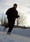 MINOT AIR FORCE BASE, N.D. – Tech. Sgt. Eddie Neher, 741st Missile Squadron missile facility manager, runs through his neighborhood here, Jan. 19, as part of his training for a running event, the Go Far Challenge. Sergeant Neher signed up for this event in spite of being diagnosed with two different health conditions recently. (U.S. Air Force photo/Airman 1st Class Jessica McConnell)