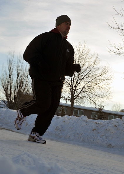 MINOT AIR FORCE BASE, N.D. – Tech. Sgt. Eddie Neher, 741st Missile Squadron missile facility manager, runs through his neighborhood here, Jan. 19, as part of his training for a running event, the Go Far Challenge. Sergeant Neher signed up for this event in spite of being diagnosed with two different health conditions recently. (U.S. Air Force photo/Airman 1st Class Jessica McConnell)