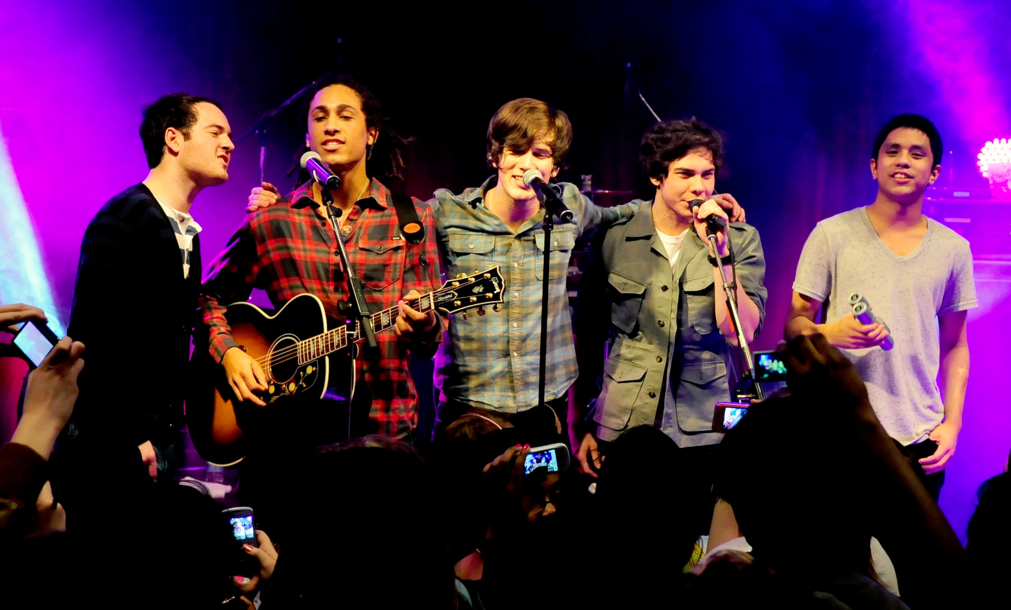 RAF MILDENHALL, England -- Members of Allstar Weekend Dillon Anderson, Nathan Darmody, Zachary Porter, Cameron Quiseng and Michael Anderson sing their last song of the evening during their concert held here Jan. 15, 2011. The goal of the concert was to boost morale and give back to military families. (U.S. Air Force photo/Senior Airman Ethan Morgan)