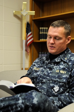 Navy Chaplain Lt. j.g. John Quay reads from the Bible during some down time at the Chapel. Lieutenant Quay originally enlisted in the Air Force in 1980. Now 48-years old, Chaplain Quay is again serving his country as a U.S. Navy chaplain with hopes of touching the lives of all the men and women serving in the military. (U.S. Navy photo/Mass Communication Specialist 1st Class Jennifer Hudson)