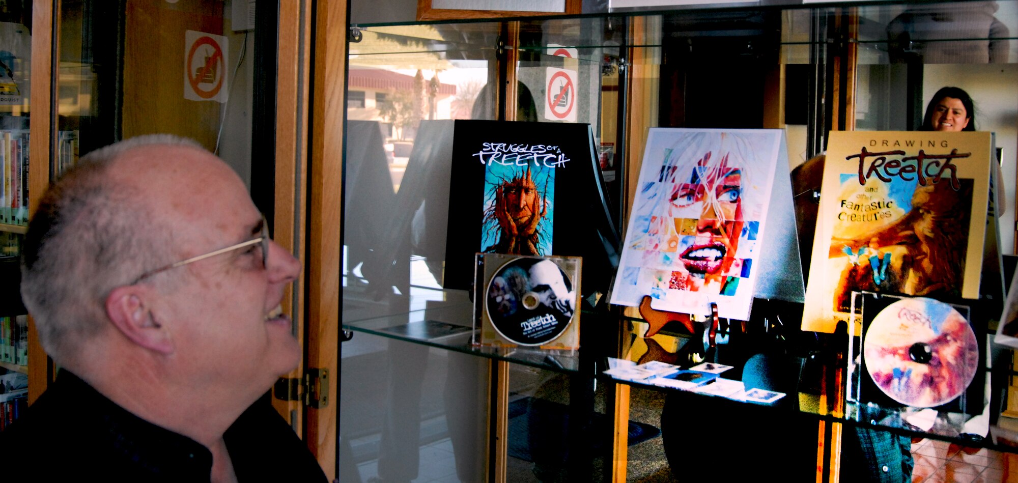 Frank Robert Dixon, an Antelope Valley artist, shows off his artwork at the Edwards Base Library. Mr. Dixon's art is on display for the month of January. (Air Force photo by Kate Blais)