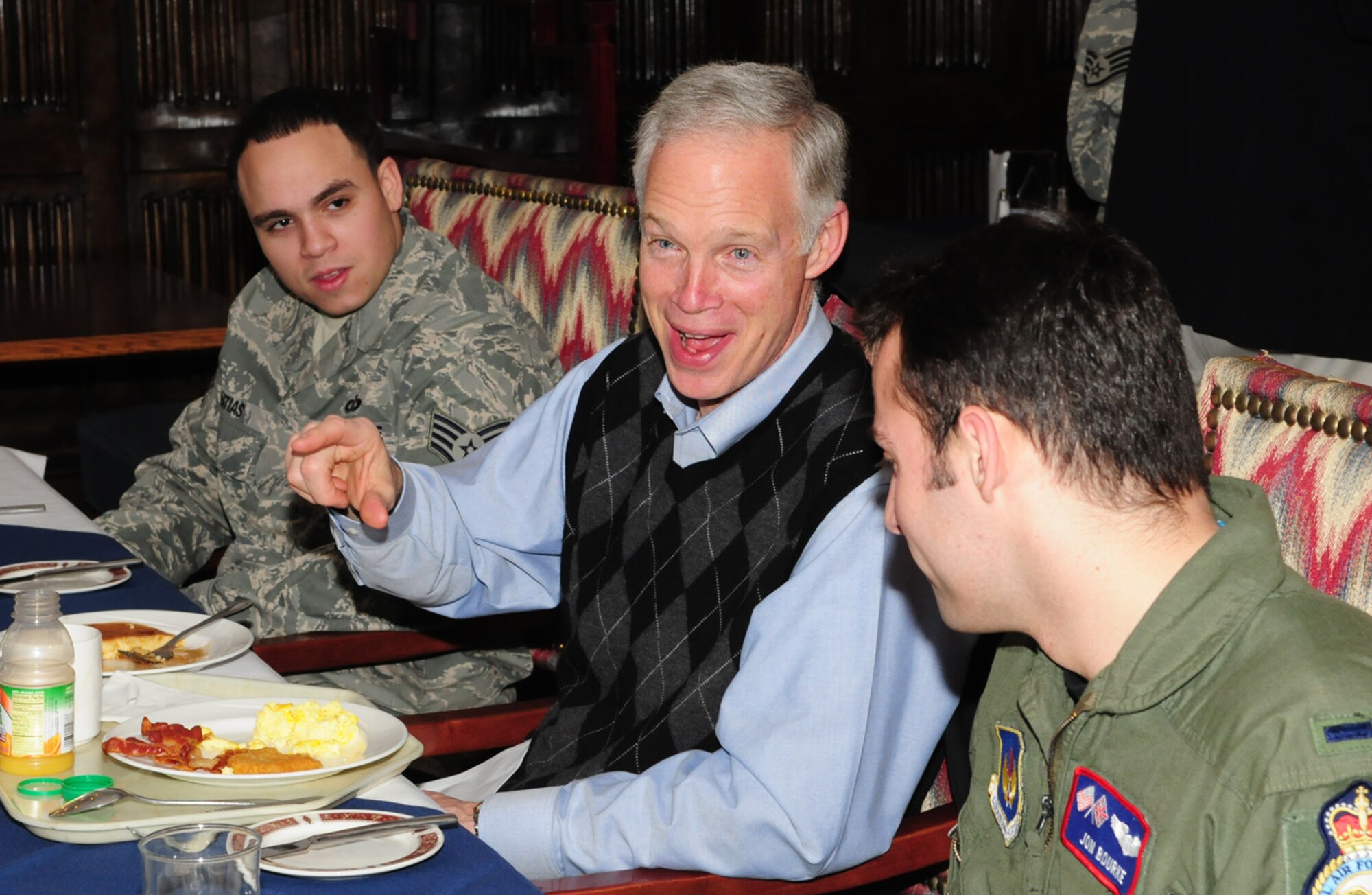RAF MILDENHALL, England – Sen. Ron Johnson, Wis., animatedly chats with Lt. John Bourke, right, 351st Air Refueling Squadron, and Staff Sgt. Joshua Matias, 100th Operations Squadron, as he answers questions from servicemembers from his state at a breakfast at the Gateway Dining Facility Jan. 18, 2010. (U.S. Air Force photo/Karen Abeyasekere)