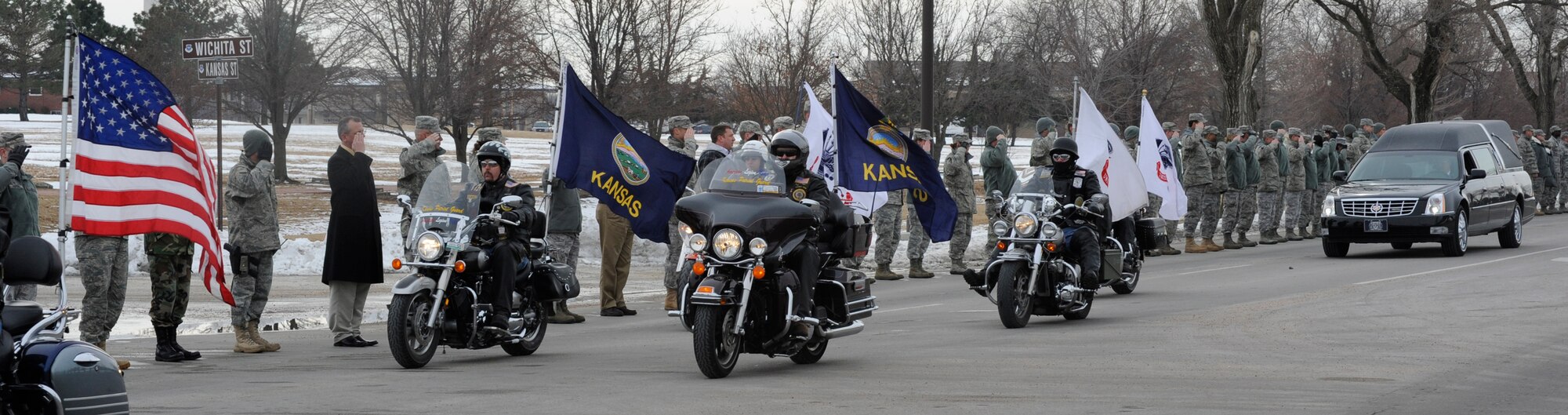 Members of the 931st Air Refueling Group and the 22nd Air Refueling Wing line the Kansas Street and salute as the hearse carrying Army Sgt. Eric Nettleton passes, Jan. 14.  Sergeant Nettleton was killed by an improvised explosive device while serving with the 2nd Stryker Cavalry in Afghanistan. Sergeant Nettleton's brother, Airman 1st Class Clayton Nettleton, serves with the 22nd Air Refueling Wing at McConnell Air Force Base.