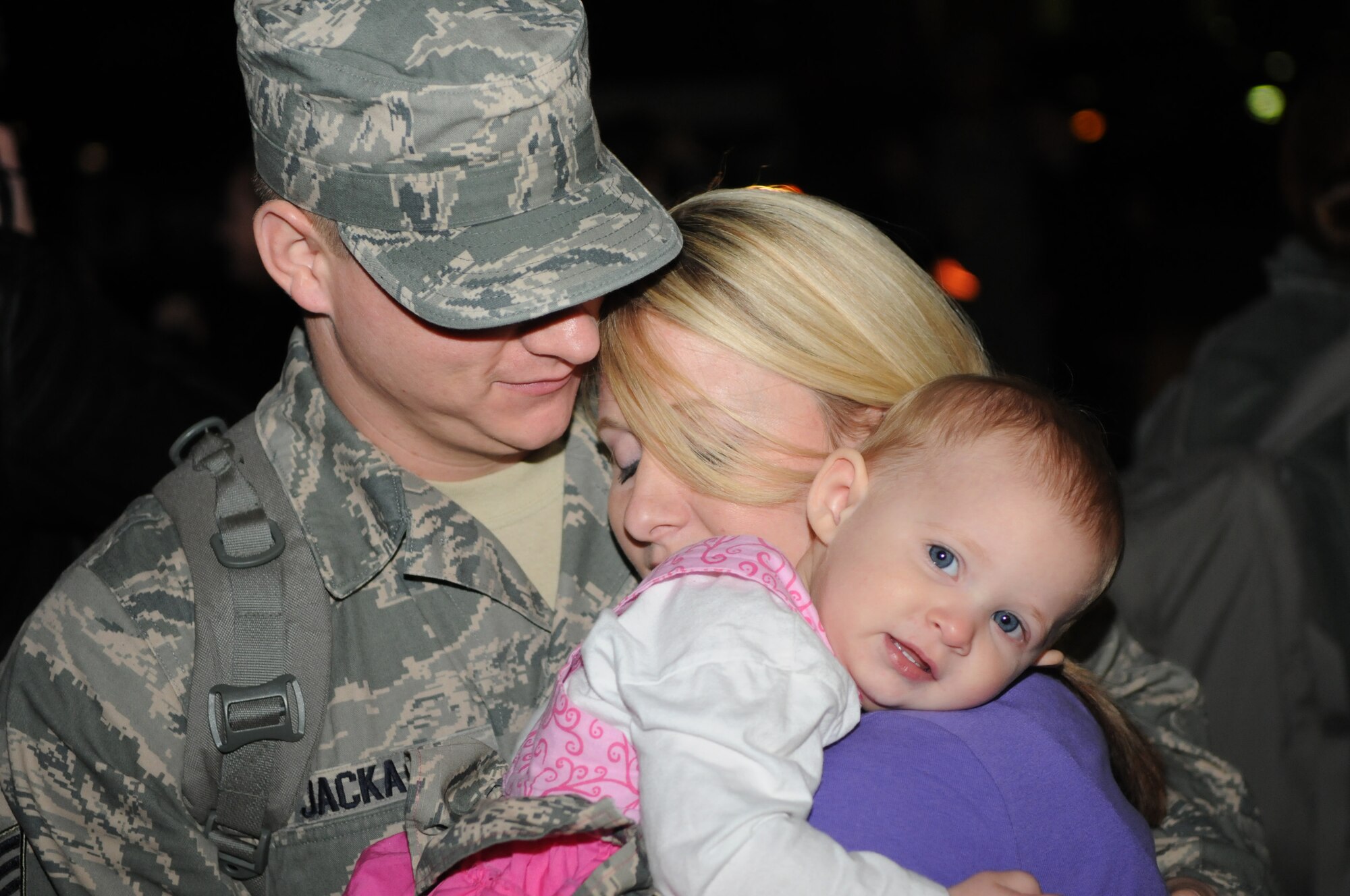 SPANGDAHLEM AIR BASE, Germany –Staff Sgt. Matthew Jacka, 606th Air Control Squadron weapons director, hugs his wife, Danielle, and their daughter Lilly after returning home from his deployment Jan 17. Seventy-one Airmen from the 606th ACS returned from multiple locations in the U.S. Central Command area of responsibility. Family members and fellow servicemembers waited to greet the Airmen upon their return after 6- and 7-month deployments. (U.S. Air Force photo/Airman 1st Class Matthew B. Fredericks)