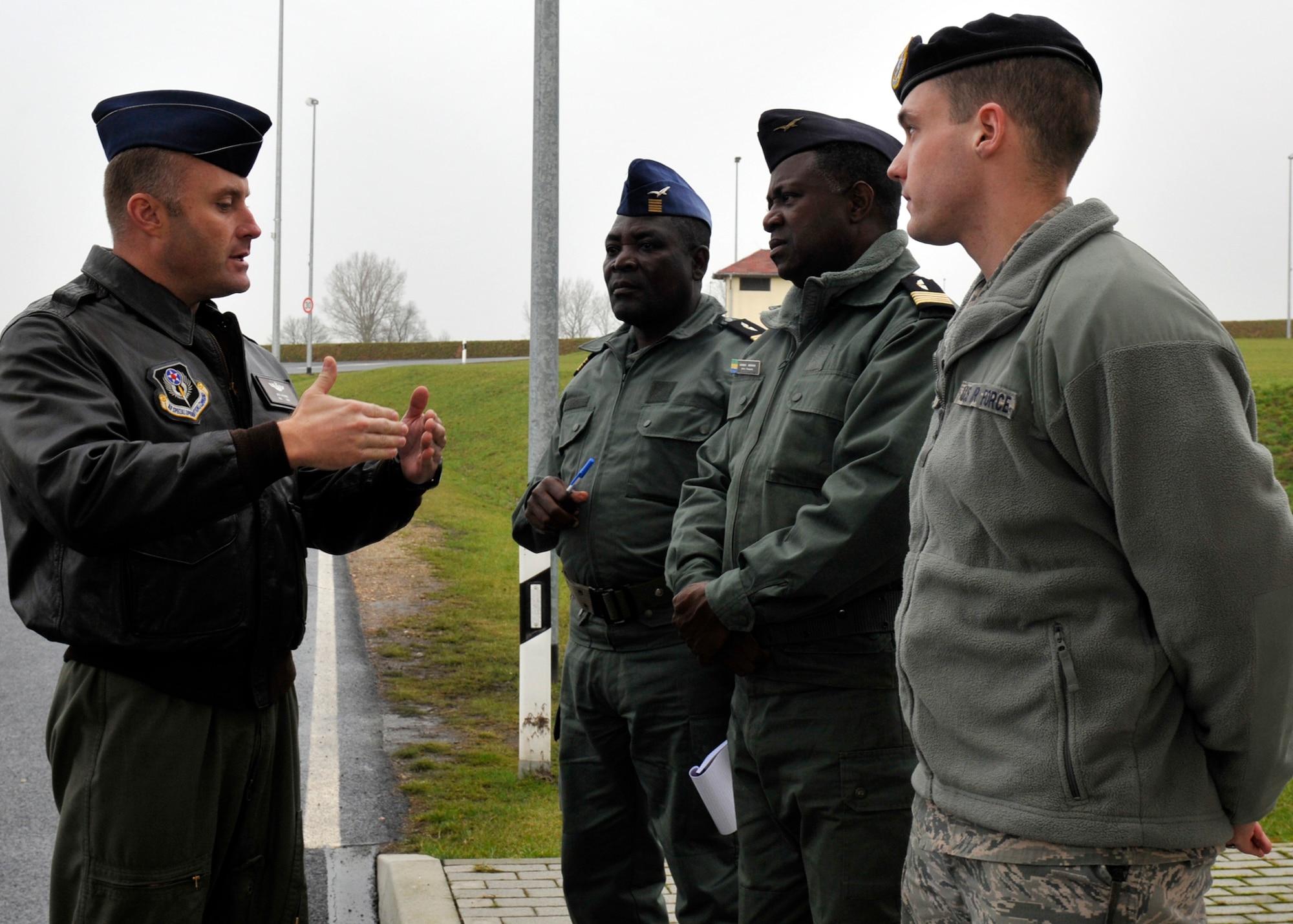 SPANGDAHLEM AIR BASE, Germany— Lt. Col. Jack Aalborg, Libreville Gabon attaché, translates a briefing given by Senior Airman Dayton Riter, 52nd Security Forces Squadron, to Col. Jean-Francois Asseko Bekogo, Mvengue Air Force Base commander (right), and Col. Jean Paulin Makoka, Libreville Air Force Base commander (left), at the south gate here Jan. 19. The 17th Air Force hosted a security familiarization for the two Gabonese commanders to show how Air Force bases function on a unit level. The commanders visited Spangdahlem to see how security and base defense are performed and to see how officers and enlisted operate together. (U.S. Air Force photo/ Airman 1st Class Brittney Frees)