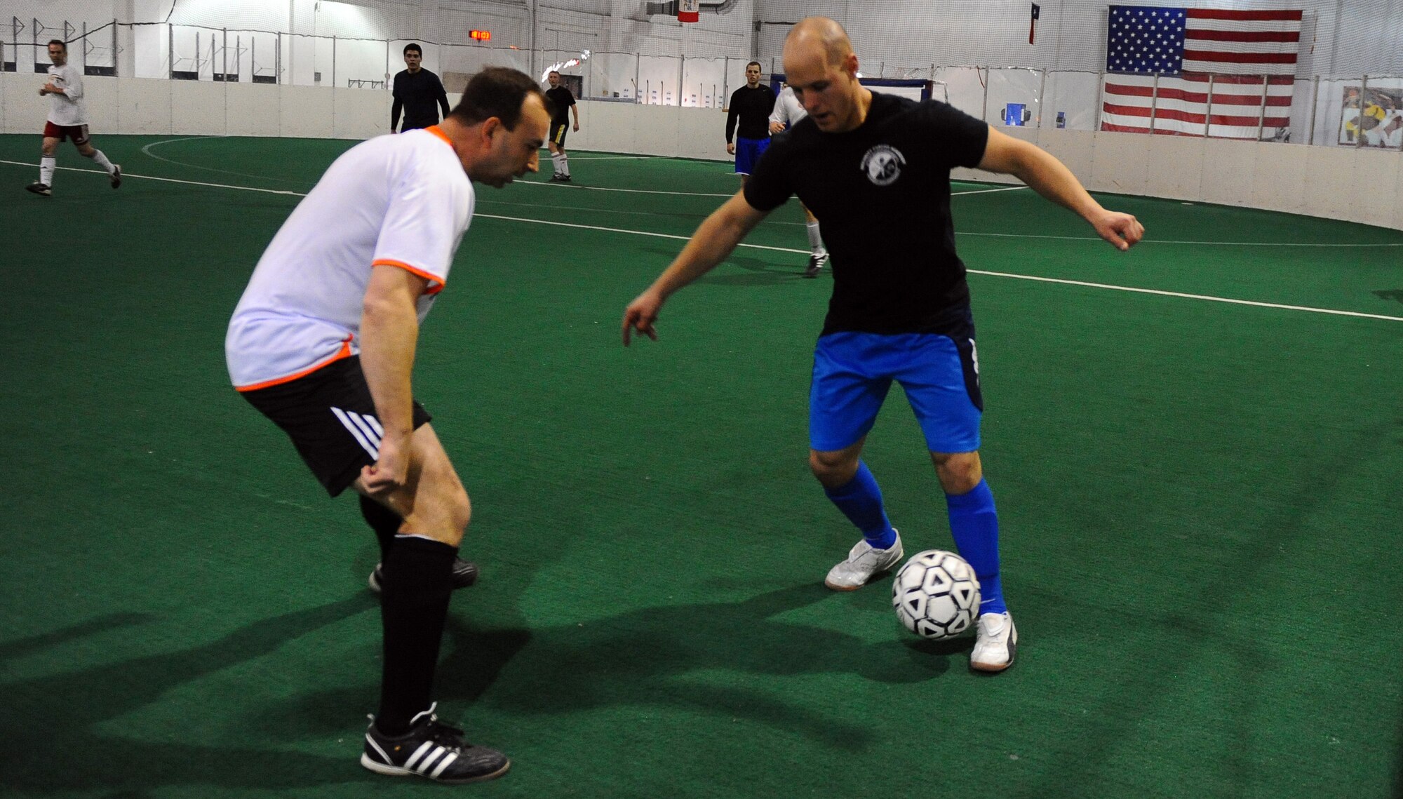 OFFUTT AIR FORCE BASE, Neb. - Airman 1st Class James Rees, assigned to the 55th Security Forces Squadron, dribbles past AFWA contractor Tom Deppe while playing a league game at the Offutt Field House, Jan. 12. The indoor soccer league is in full swing for the 2011 season. U.S. Air Force Photo by Josh Plueger
(Released) 
