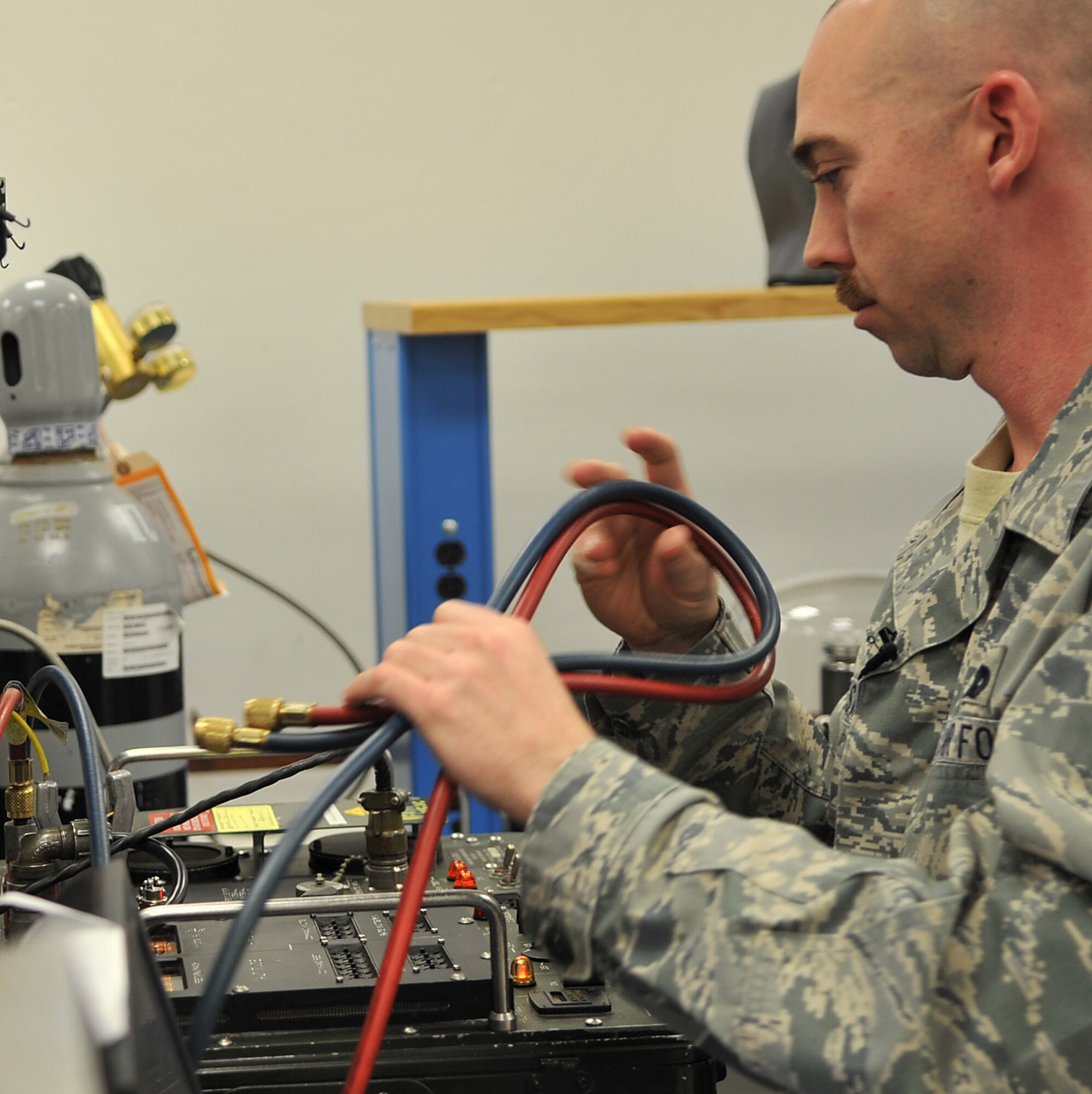 U.S. Air Force Staff Sgt. Stephen Reesman, 86th Maintenance Squadron Test Measurement and Diagnostic flight technician, puts away a calibrator after giving familiarization training to maintenance members, Ramstein Air Base, Germany, Jan. 19, 2010. The flight consists of a scheduling section, shipping and receiving section, administration section and the Precision Measurement Equipment Laboratory (PMEL) and services customers throughout United States Air Forces in Europe, United States Central Command, and United States Africa Command. (U.S. Air Force photos by Senior Airman Caleb Pierce)