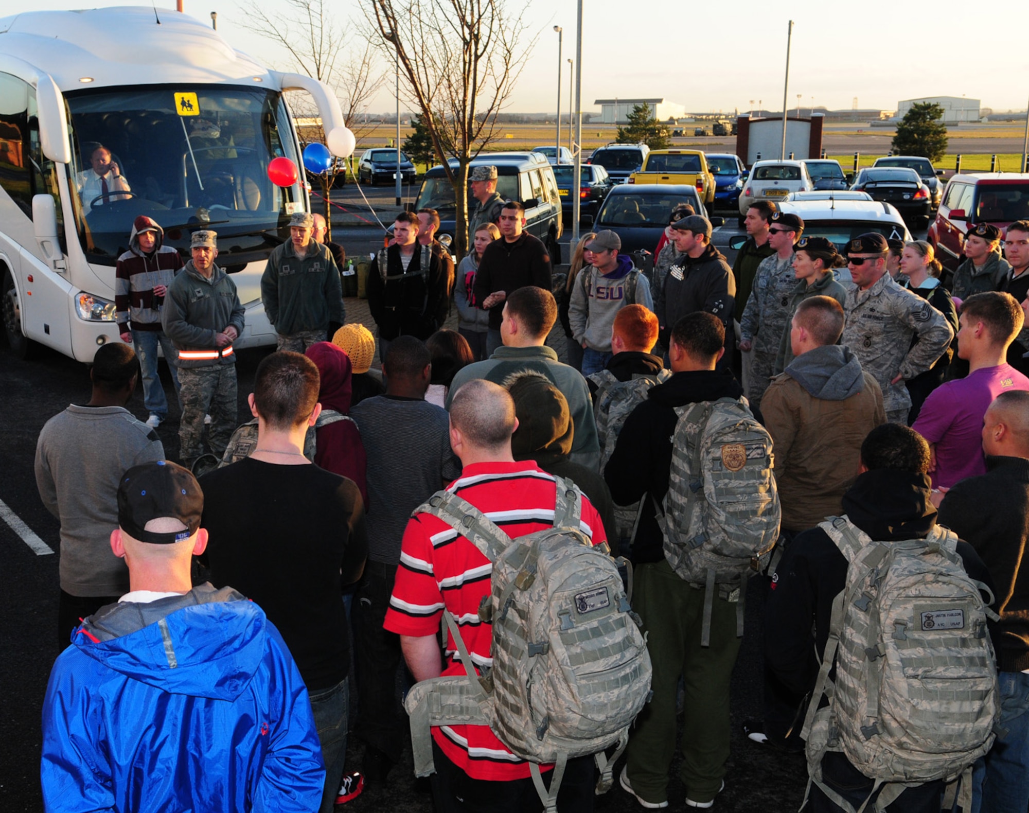 RAF MILDENHALL, England -- Col. Chad Manske, 100th Air Refueling Wing commander (wearing reflective belt), welcomes home 100th Security Forces Squadron troops from their deployment Jan. 18, 2011, as they are met by family, friends and coworkers here. Three groups of 100th SFS members returned from  deployments of between three and six months. (U.S. Air Force photo/Karen Abeyasekere)
