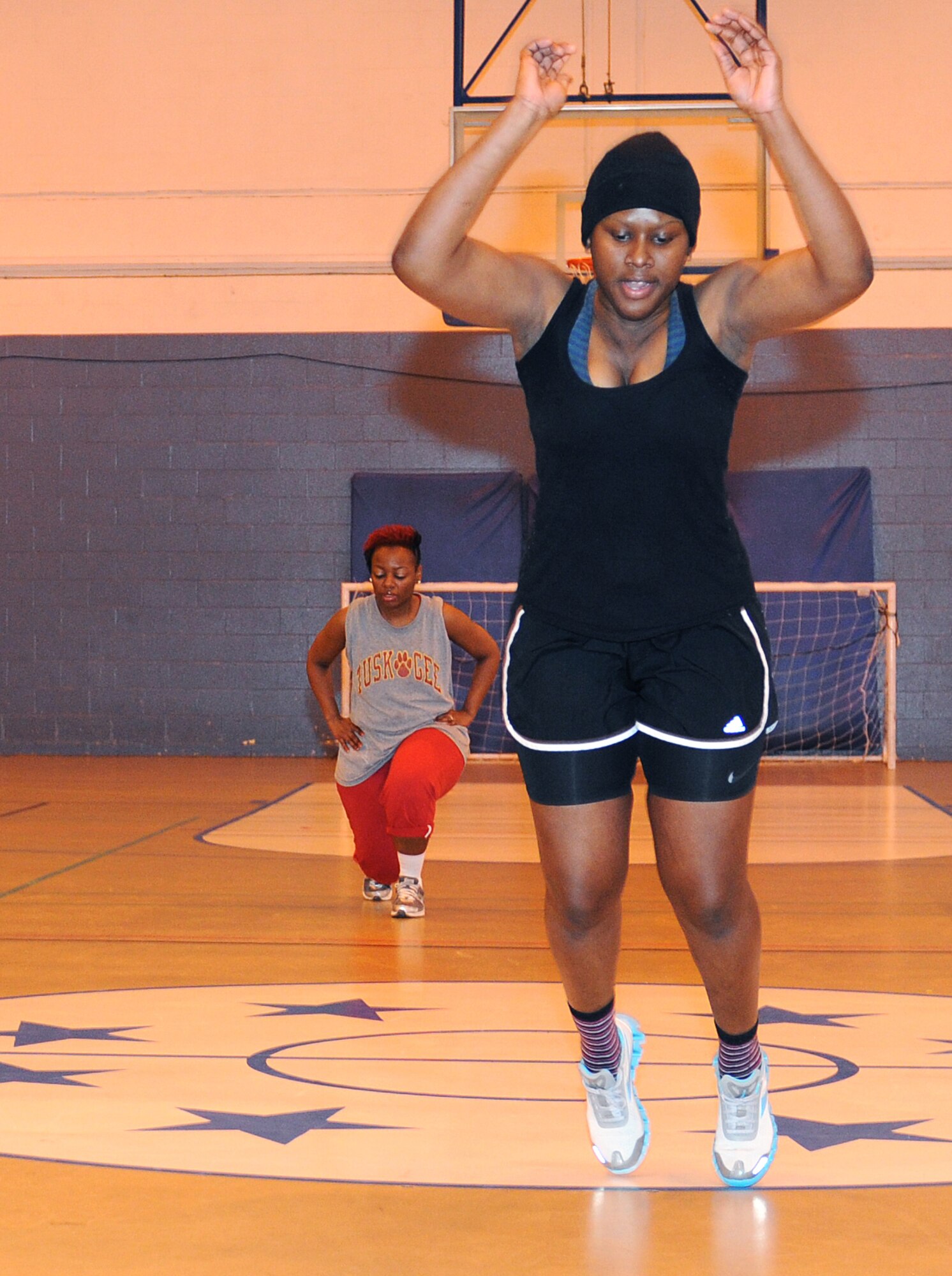 RAF MILDENHALL, England -- Kayon McFarlane leaps across the gym floor during a High Intensity Interval Training class here Jan. 13, 2011. Mrs. McFarlane is participating in the Biggest Loser competition and her goal is to lose 38 pounds. (U.S. Air Force photo/Senior Airman Tabitha M. Lee) 