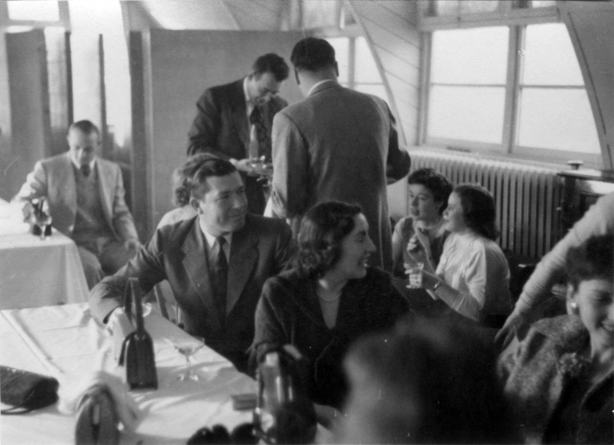 ROYAL AIR FORCE WETHERSFIELD, England -- Several 77th Fighter Squadron F-84 pilots and their wives talk among themselves at the first Gambler's Brunch at the officer's club at RAF Wethersfield, England Dec. 26, 1952. (Courtesy photo)