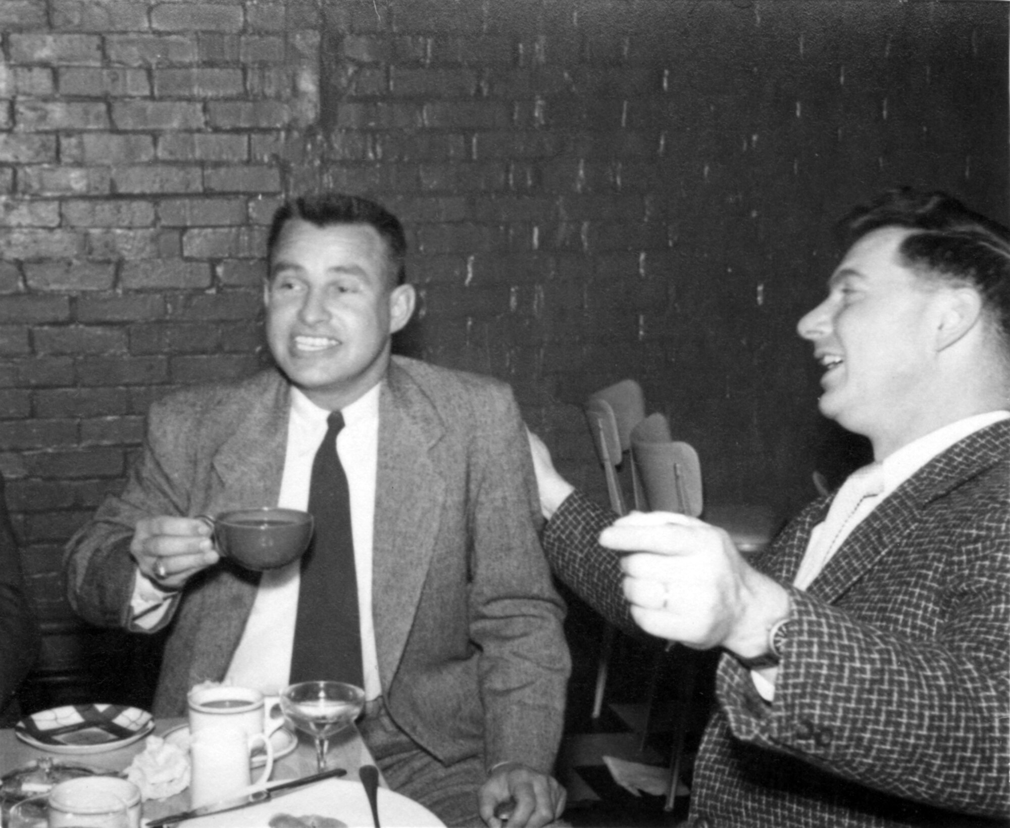 ROYAL AIR FORCE WETHERSFIELD, Enlgand -- Major Owen Brewer and another 77th Fighter Squadron F-84 pilot talk and drink coffee at the first Gambler Brunch at the officers club at RAF Wethersfield, England Dec. 26, 1952. (Courtesy photo)  