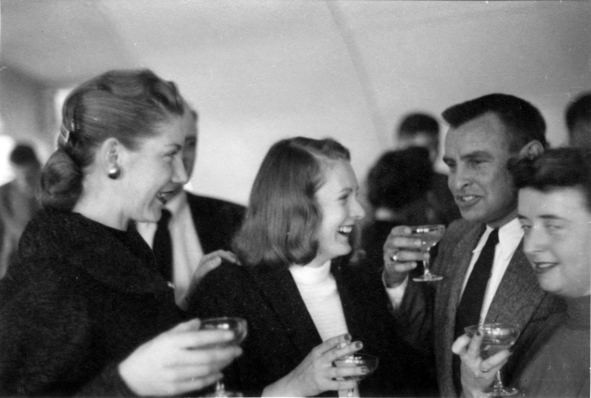 ROYAL AIR FORCE WETHERSFIELD, England -- Major Owen Brewer, 77th Fighter Squadron F-84 pilot, and his wife, Peg Brewer, talk with some of the the other wives at the first 77th Fighter Squadron brunch at RAF Wethersfield, England Dec. 26, 1952. (Courtesy photo)