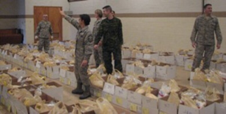 Senior Master Sgt Maureen Dooley directs EADS volunteers during delivery of Thanksgiving food baskets in Rome, N.Y. Nearly 30 Airmen and Canadian Forces members from EADS supported the American Red Cross effort. 